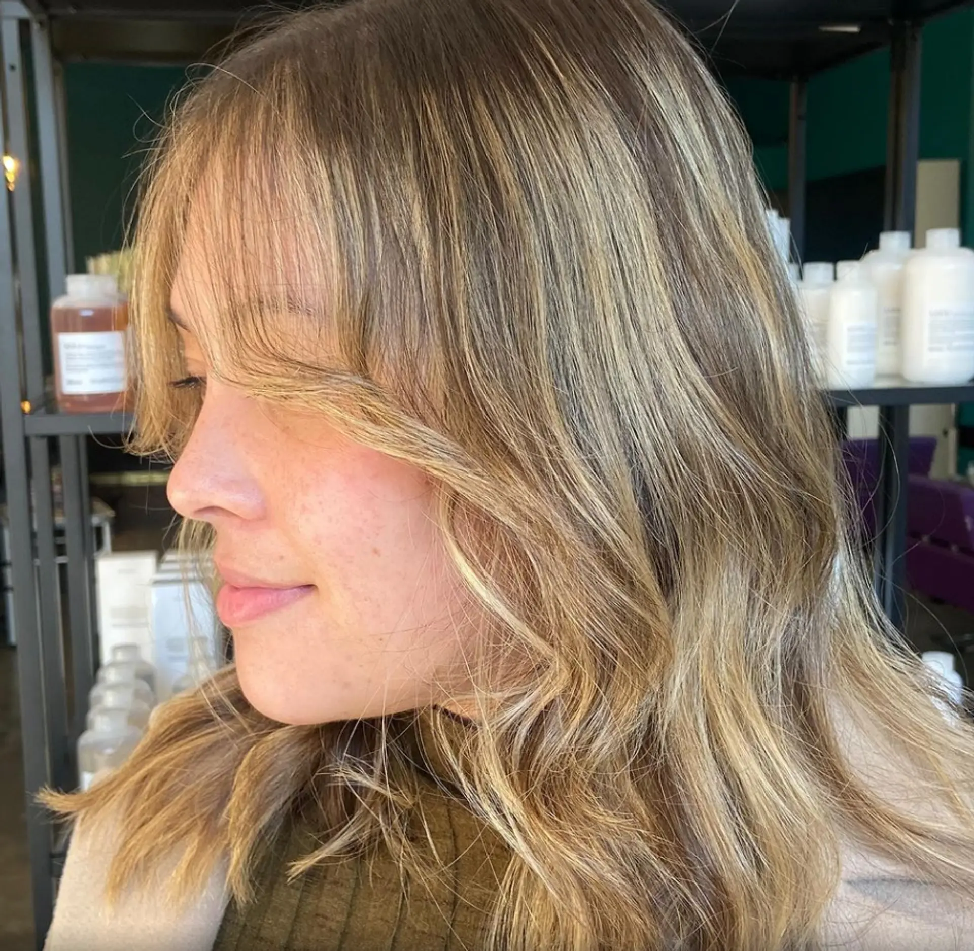 Medium-length wavy hair with blonde and light brown tones, soft layers, and golden highlights creating a natural, flowing look. 1