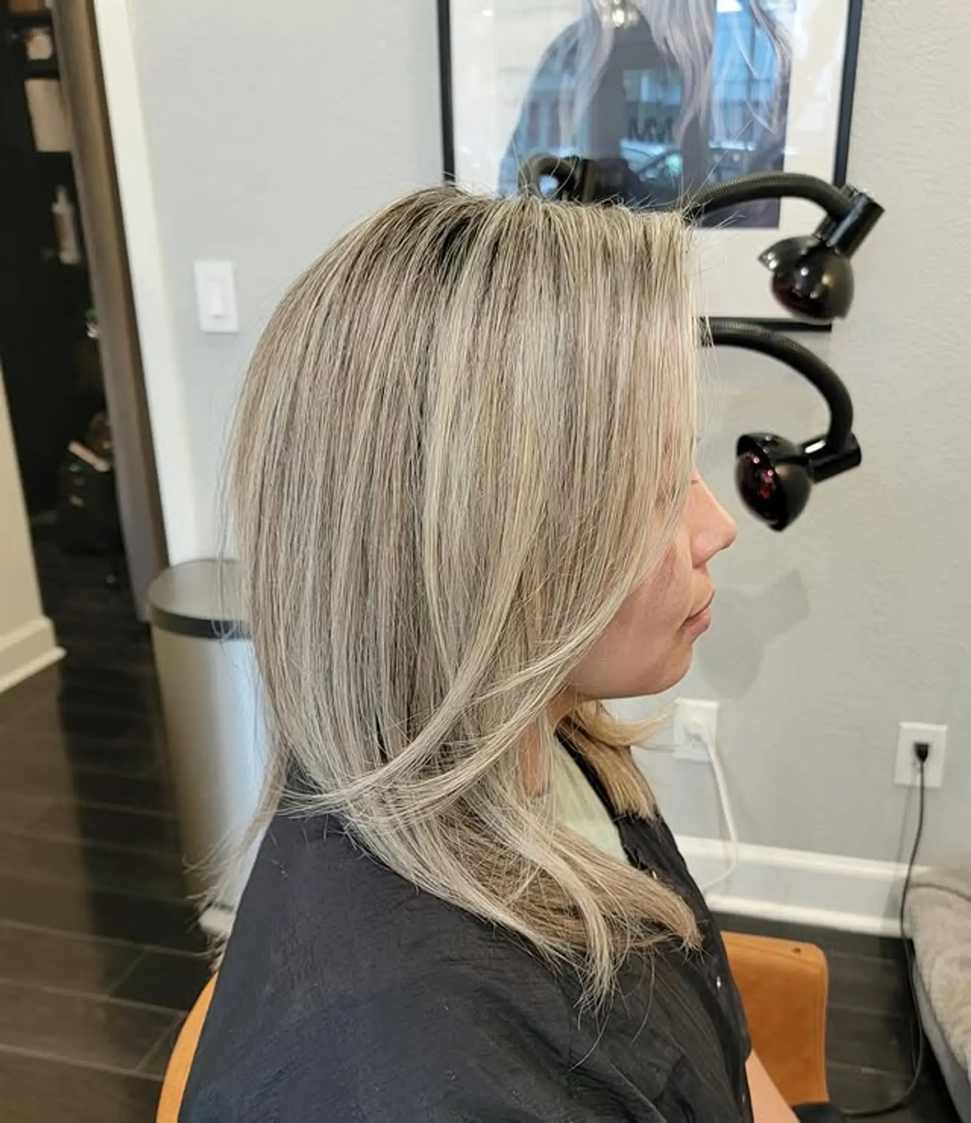 A sophisticated medium-length lob featuring a dimensional ash blonde balayage, complete with soft layers and face-framing pieces that add movement and a modern touch. 1