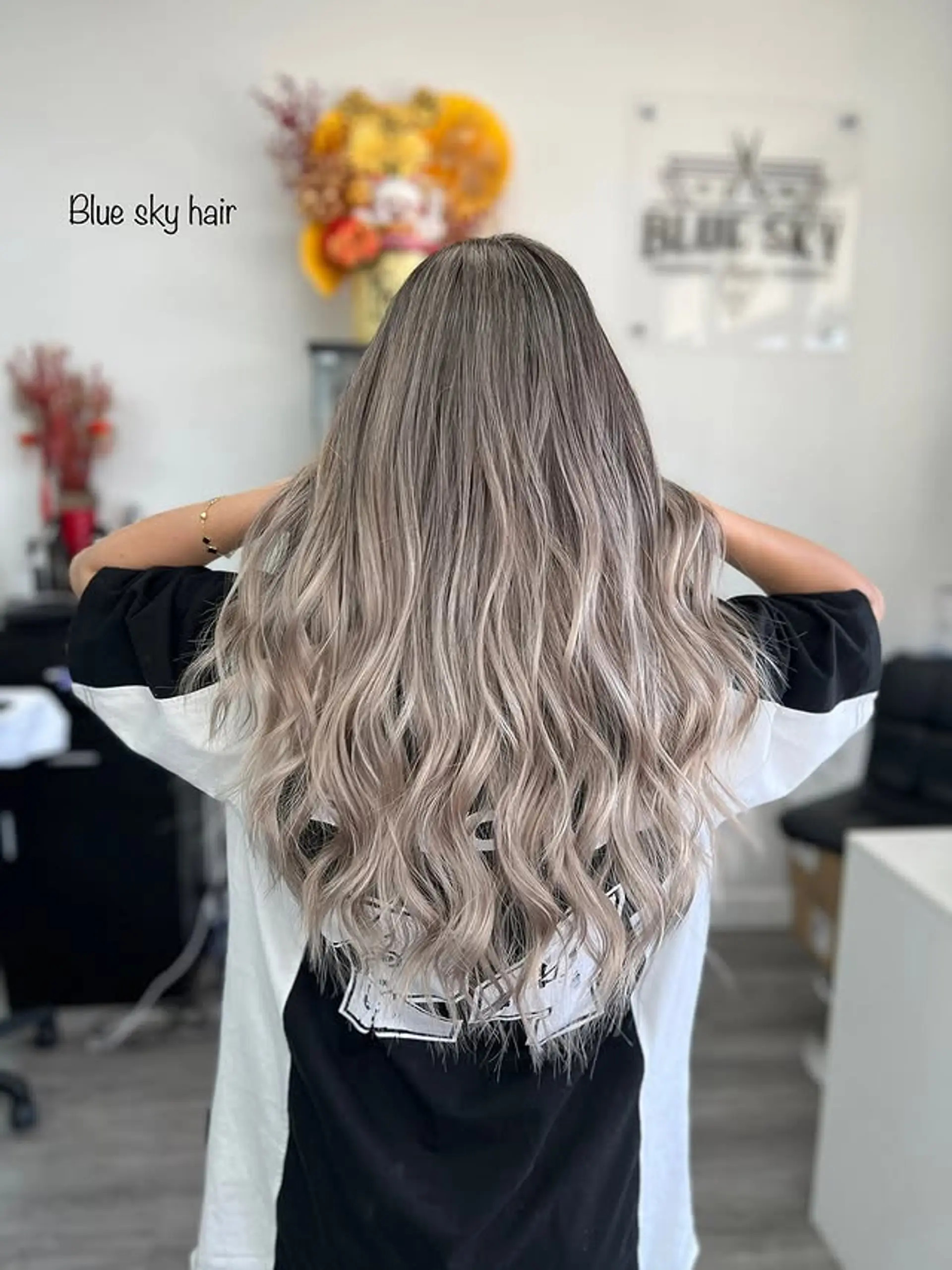 A stylish ash blonde balayage hairstyle with soft, flowing waves. 1