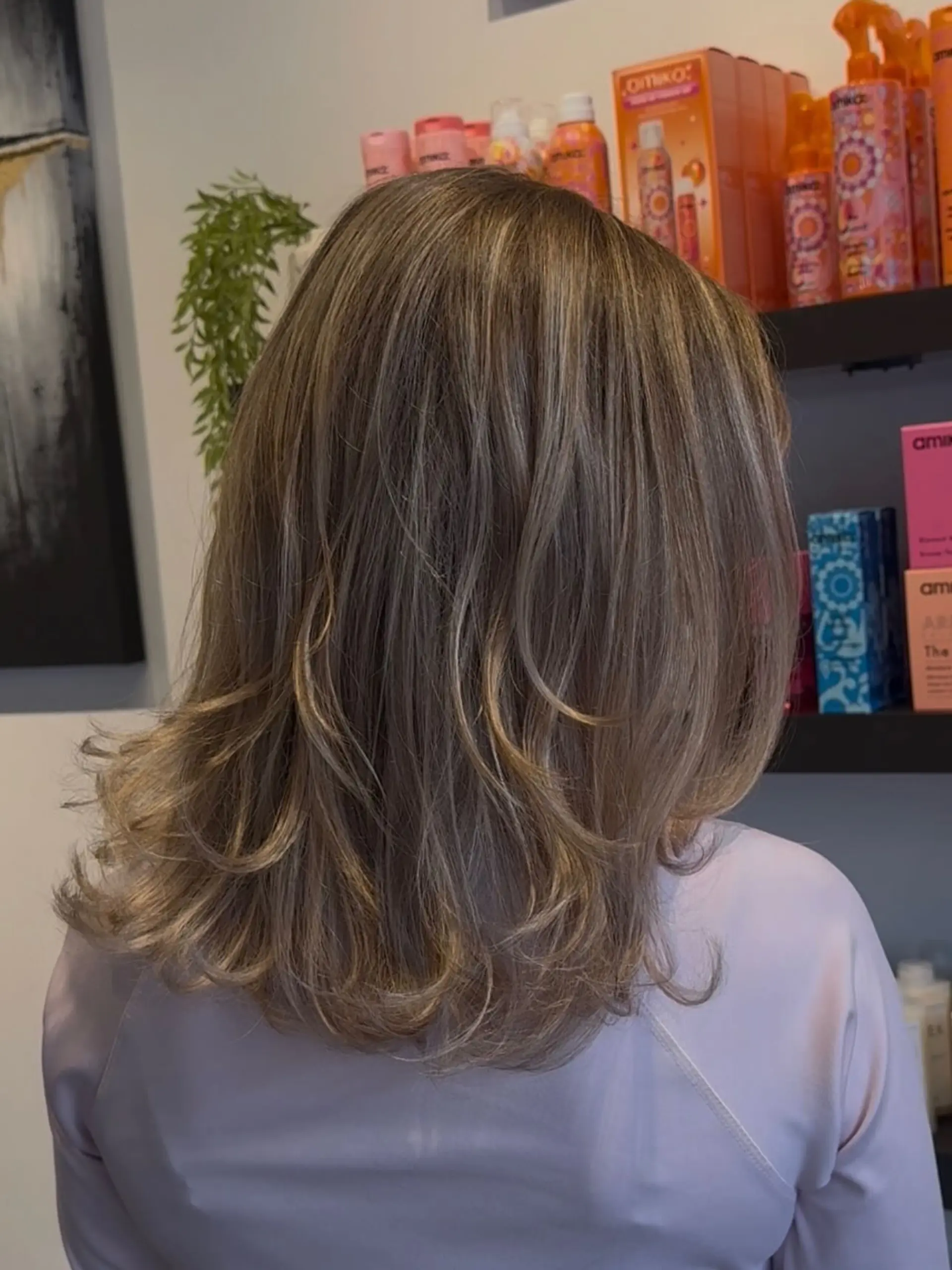 Medium-length dimensional blonde hair featuring blended highlights with soft flipped-out layers. 1