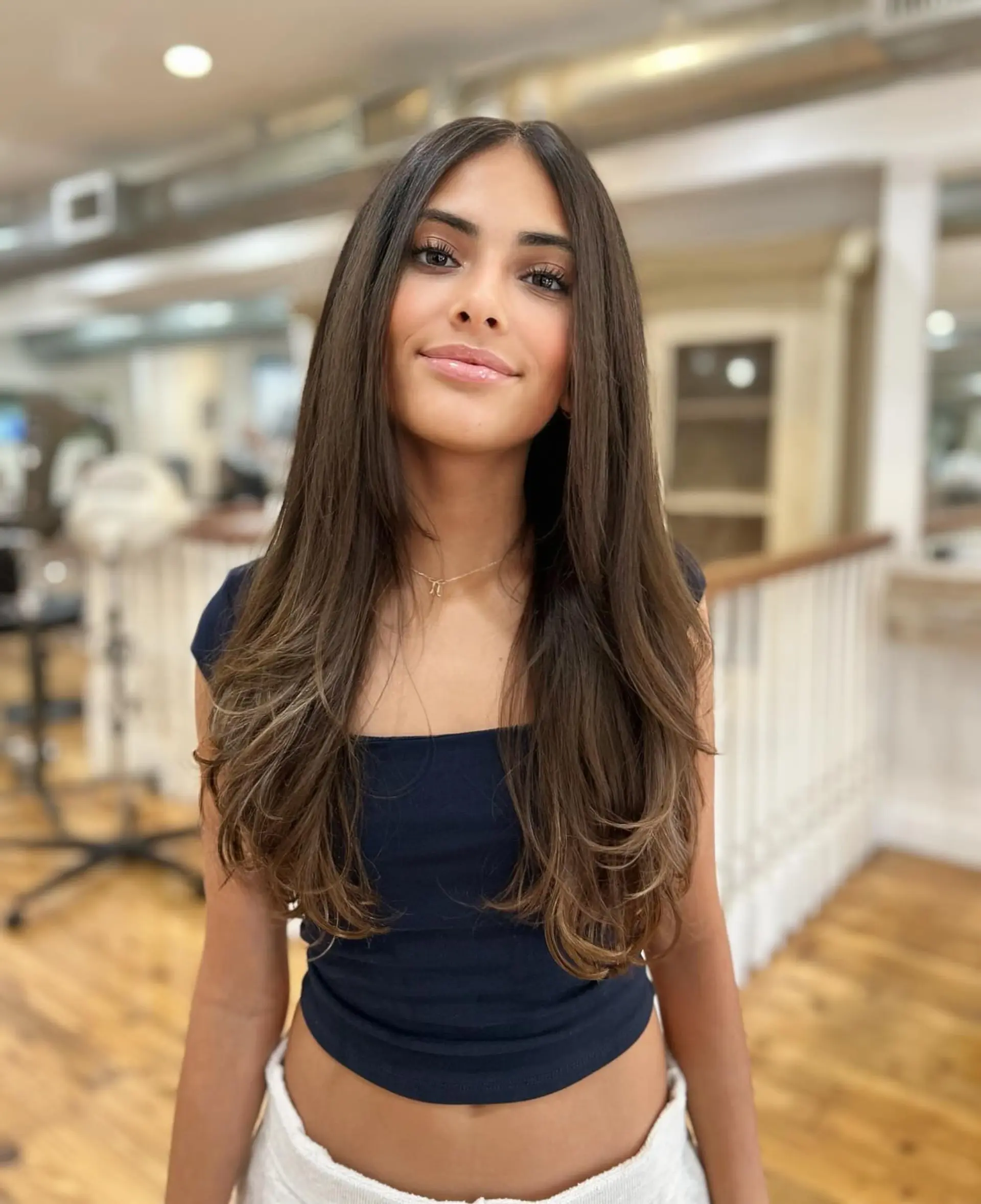 Long layered hair with a subtle balayage. 1