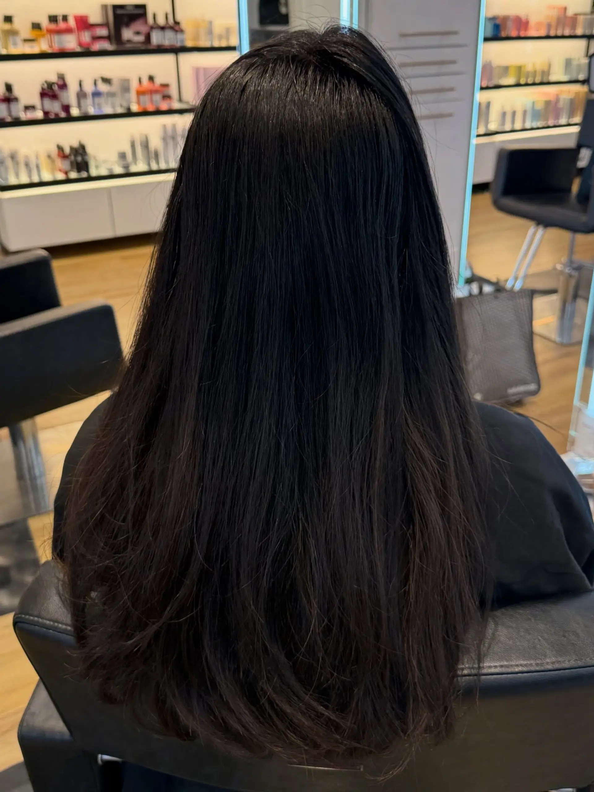 Long, glossy dark chocolate brown hair cascading straight down the back with soft texture at the ends. 1