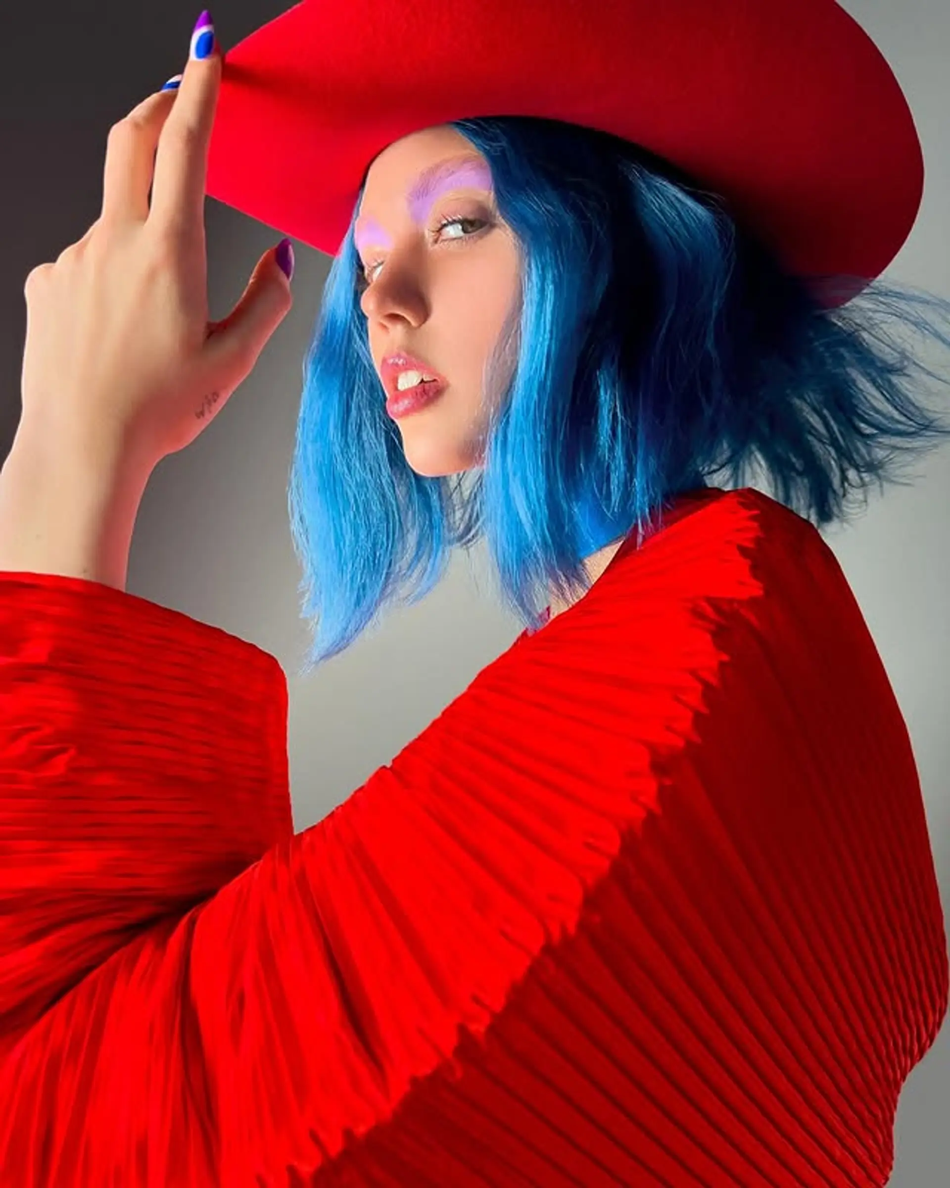 A medium-length bob haircut dyed a vibrant blue. 1