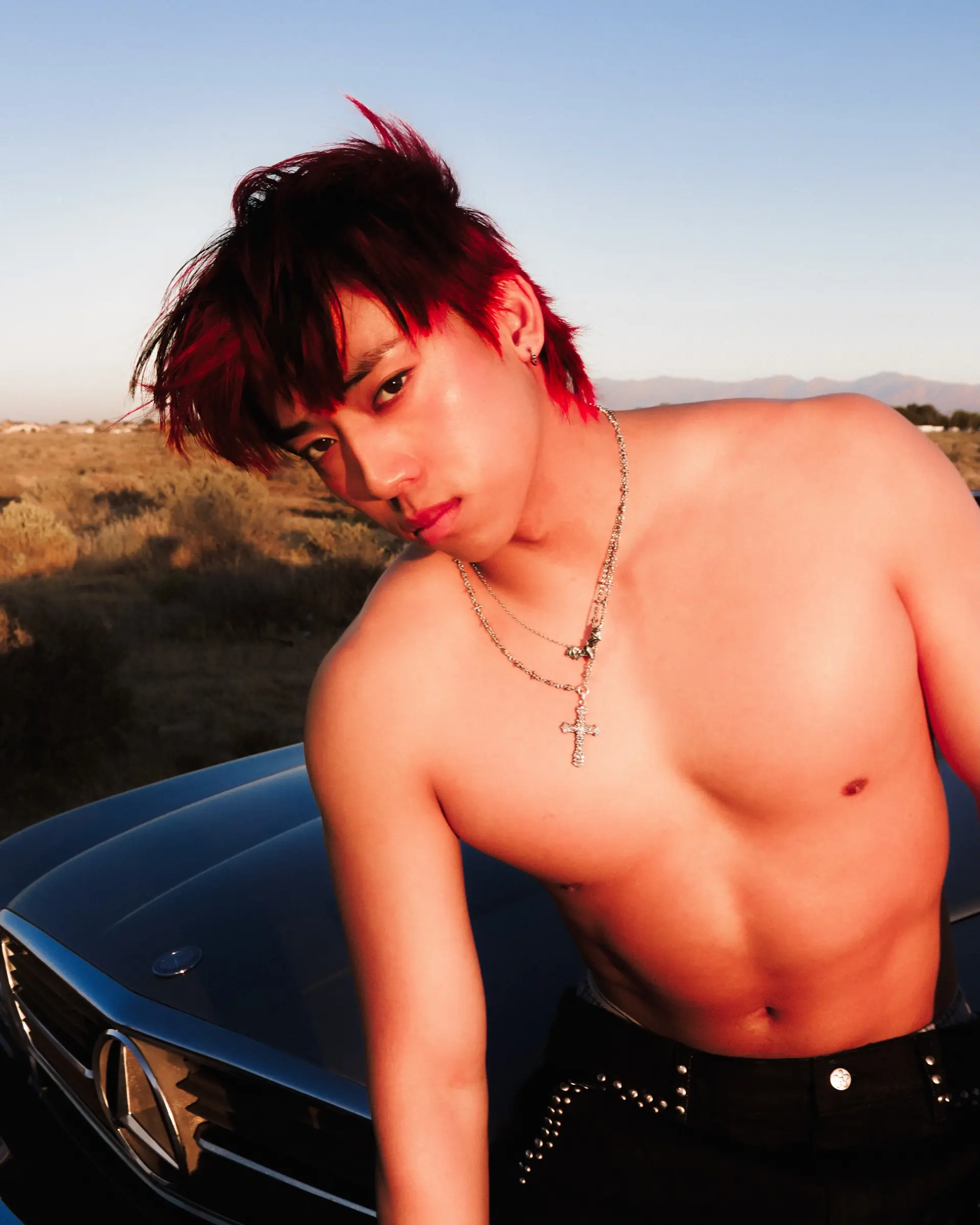 A bold, edgy modern mullet featuring vivid crimson red color with choppy, pieced-out bangs and longer layers at the nape. 1
