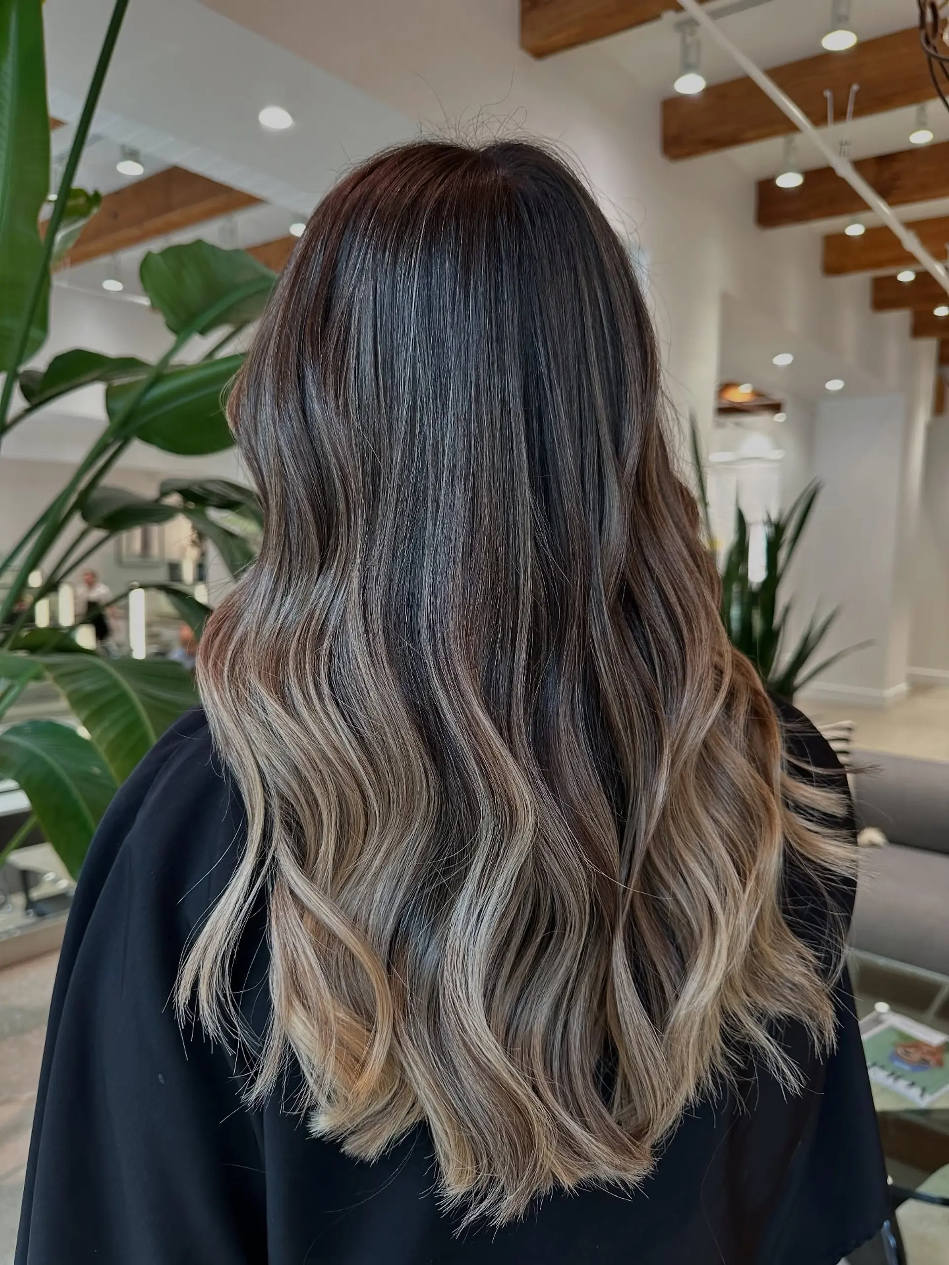Long, wavy hair with a rooted blonde balayage. 1
