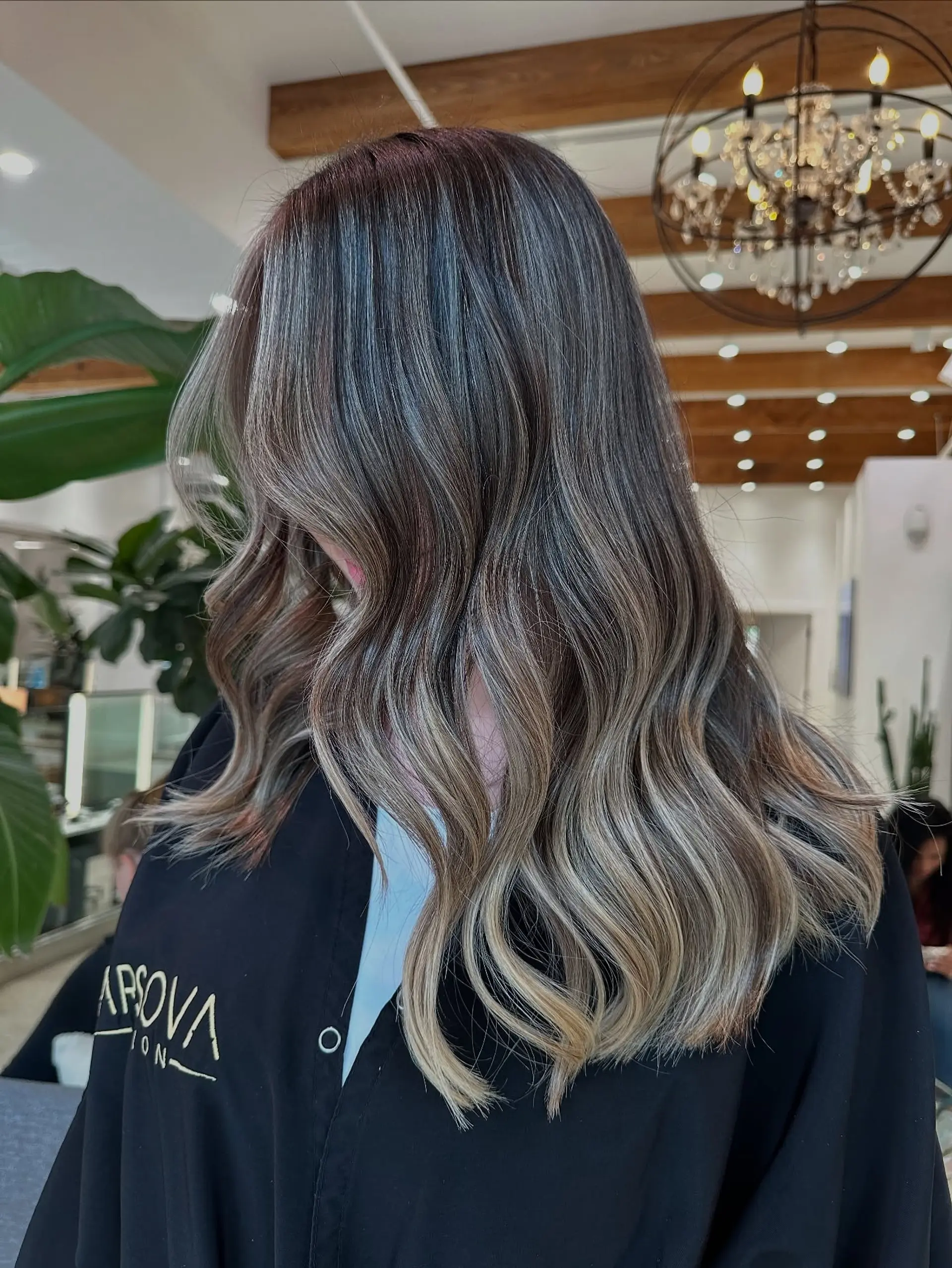 Long, wavy hair with a rooted blonde balayage. 2