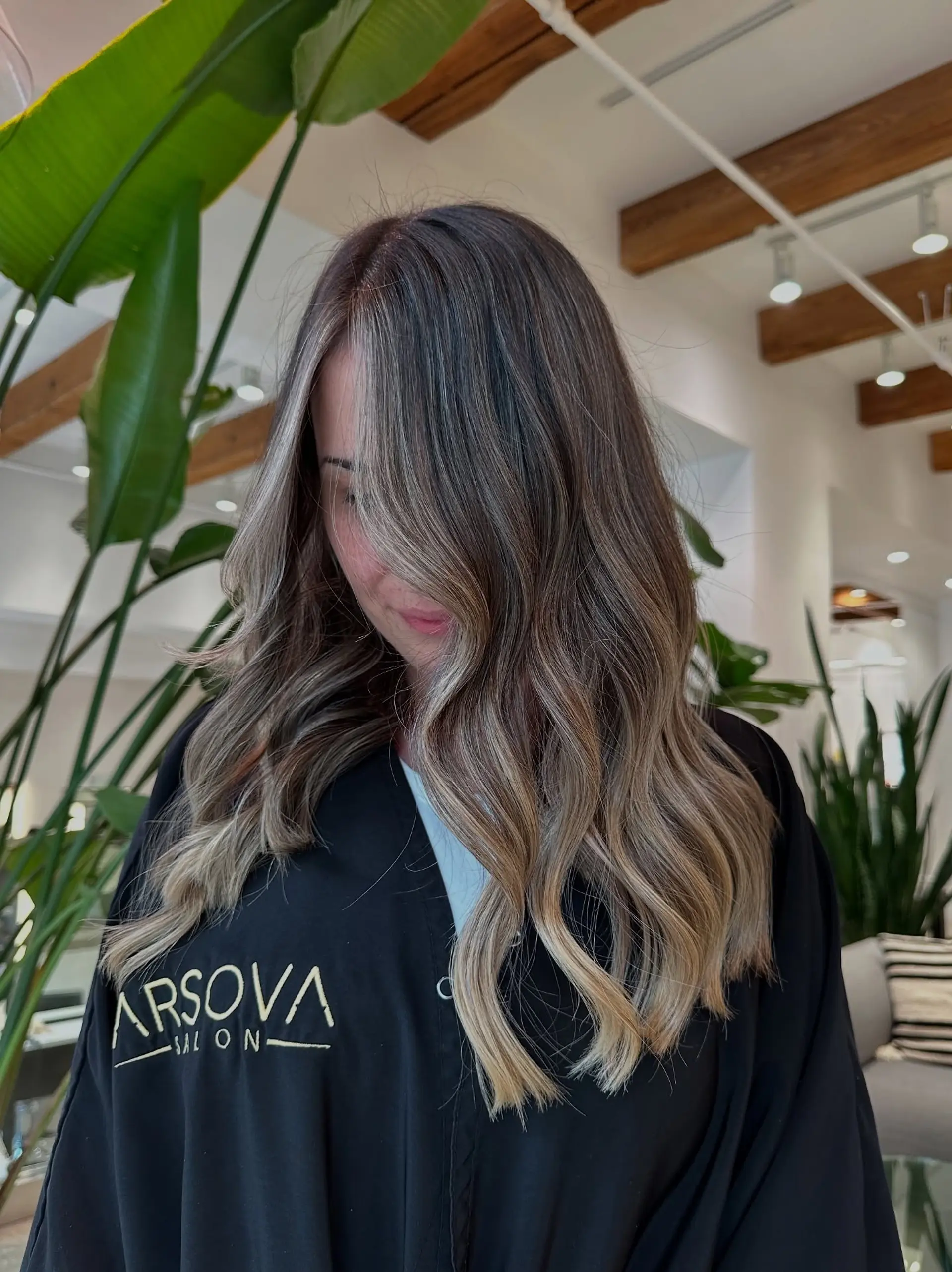 Long, wavy hair with a rooted blonde balayage. 3