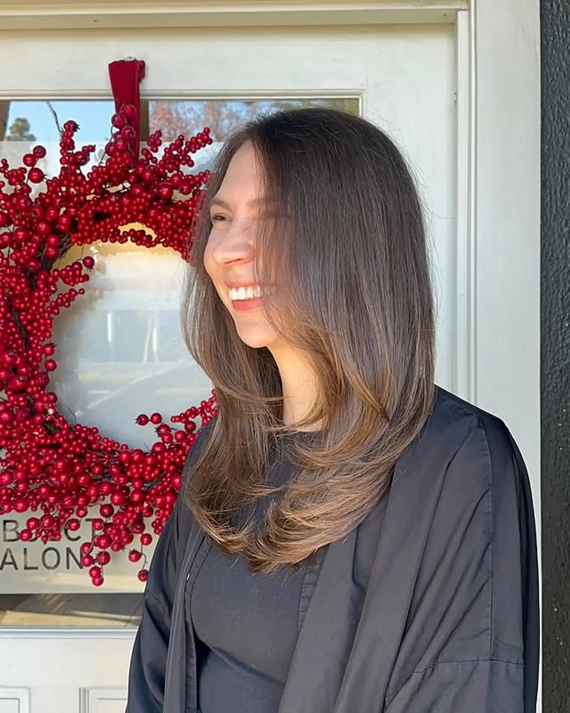 A chic medium-length layered hairstyle with a blend of brown and blonde hues. 1