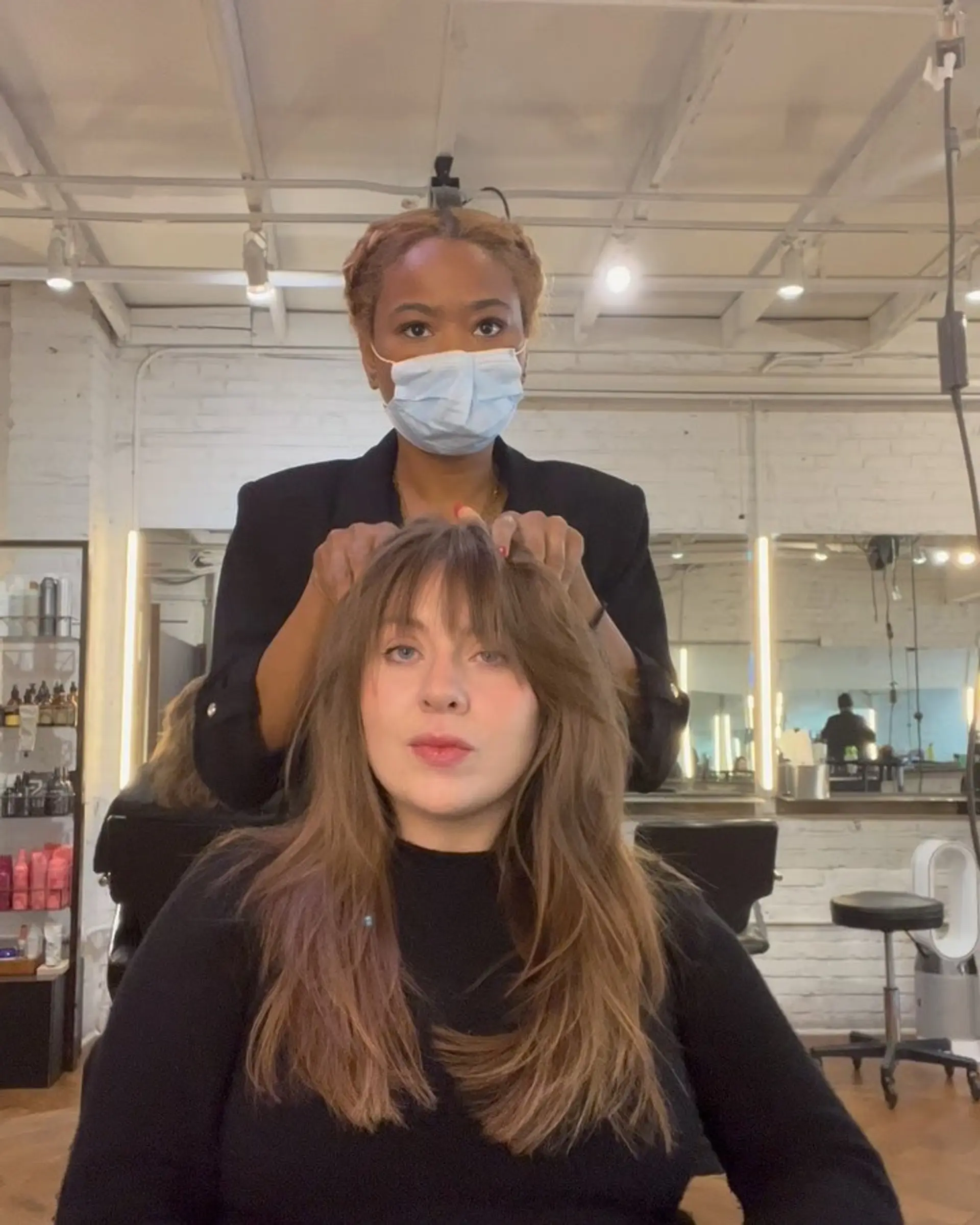 Long layered haircut featuring wispy fringe bangs and textured, face-framing layers. 1