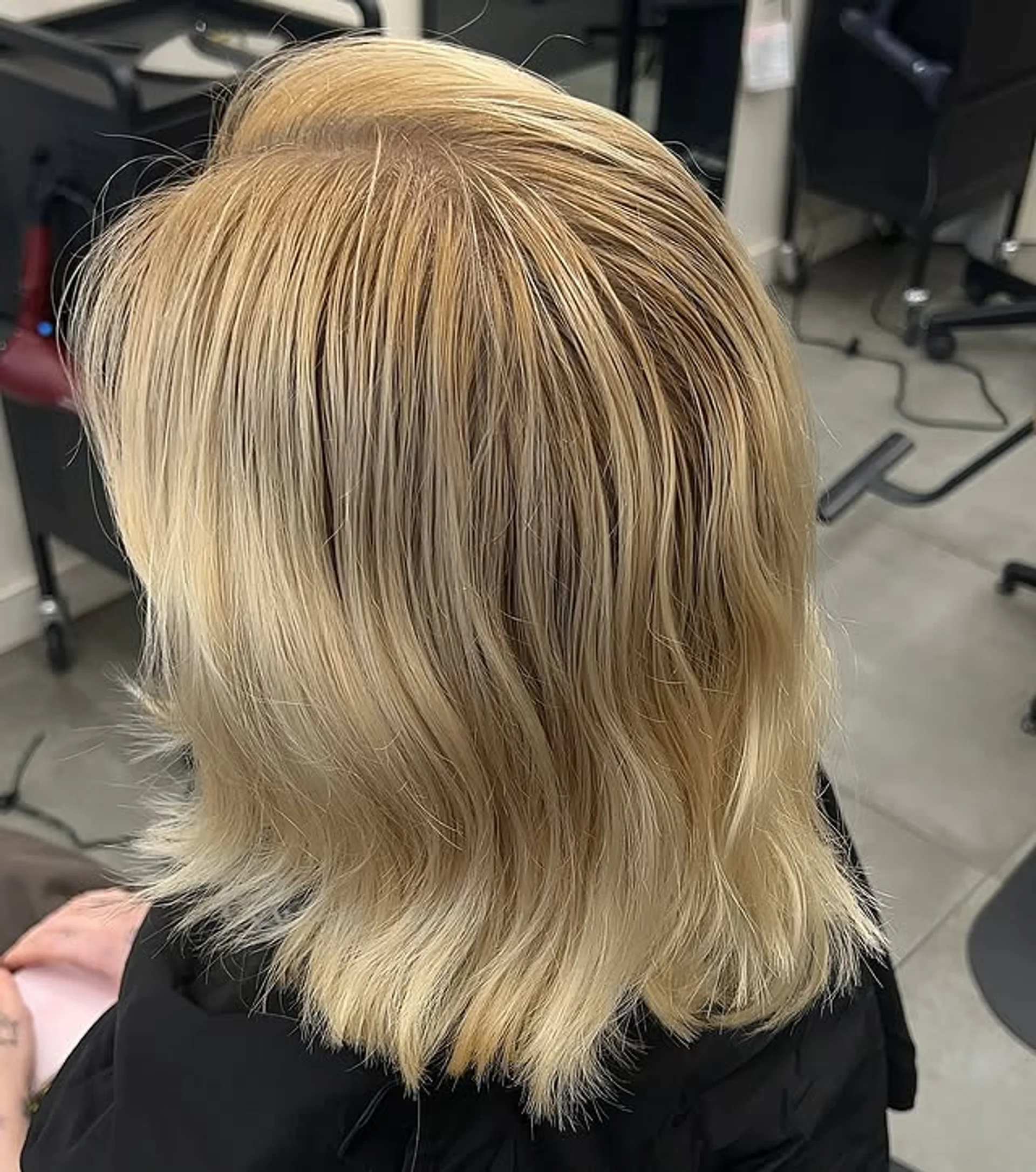 A model with a medium-length icy blonde shag haircut with Bardot bangs, a key trend for 2026. - Preview 1