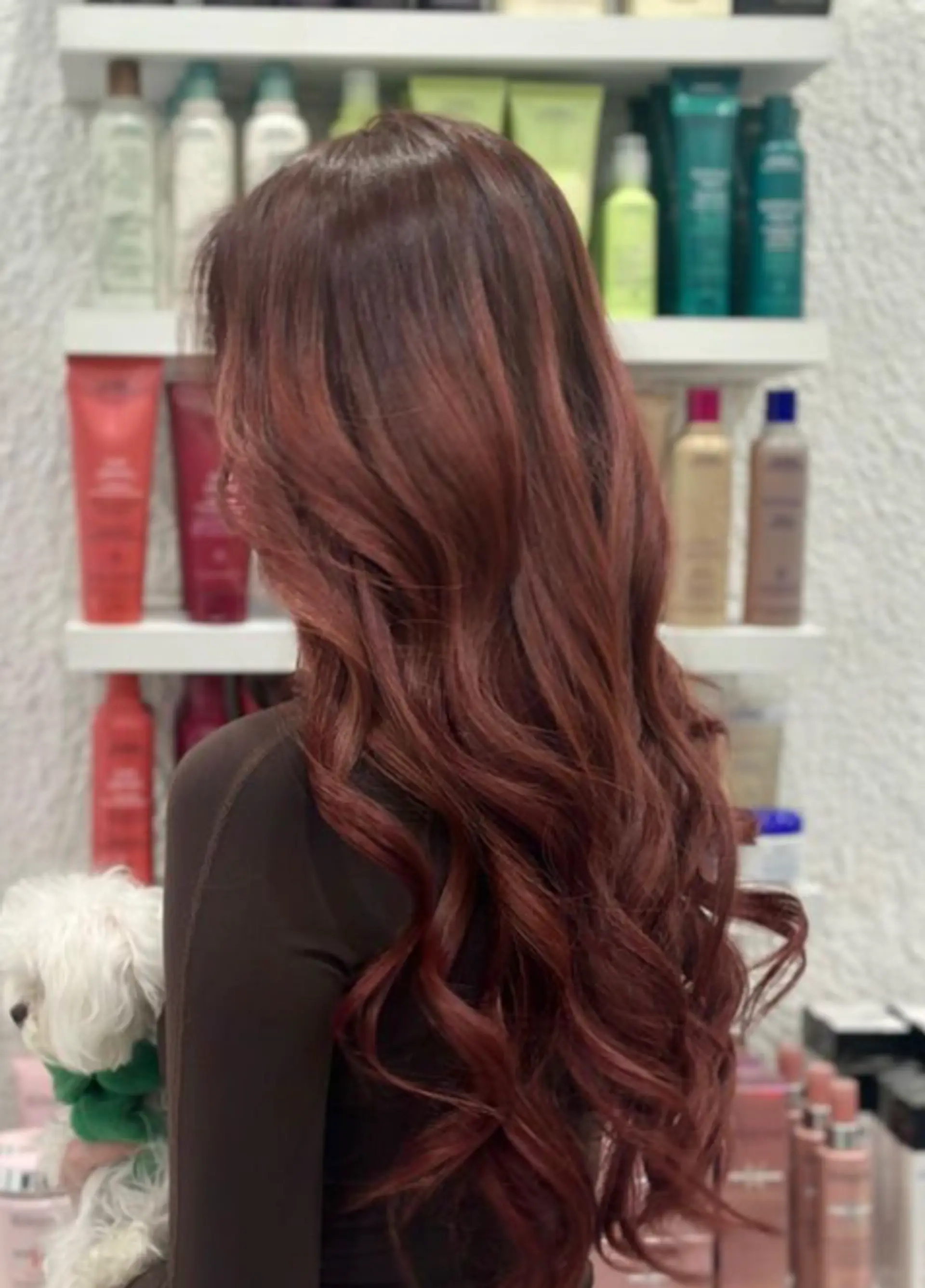 Luxurious and very long auburn hairstyle with copper highlights. Wavy texture with soft curls and long layers for depth and movement. 1