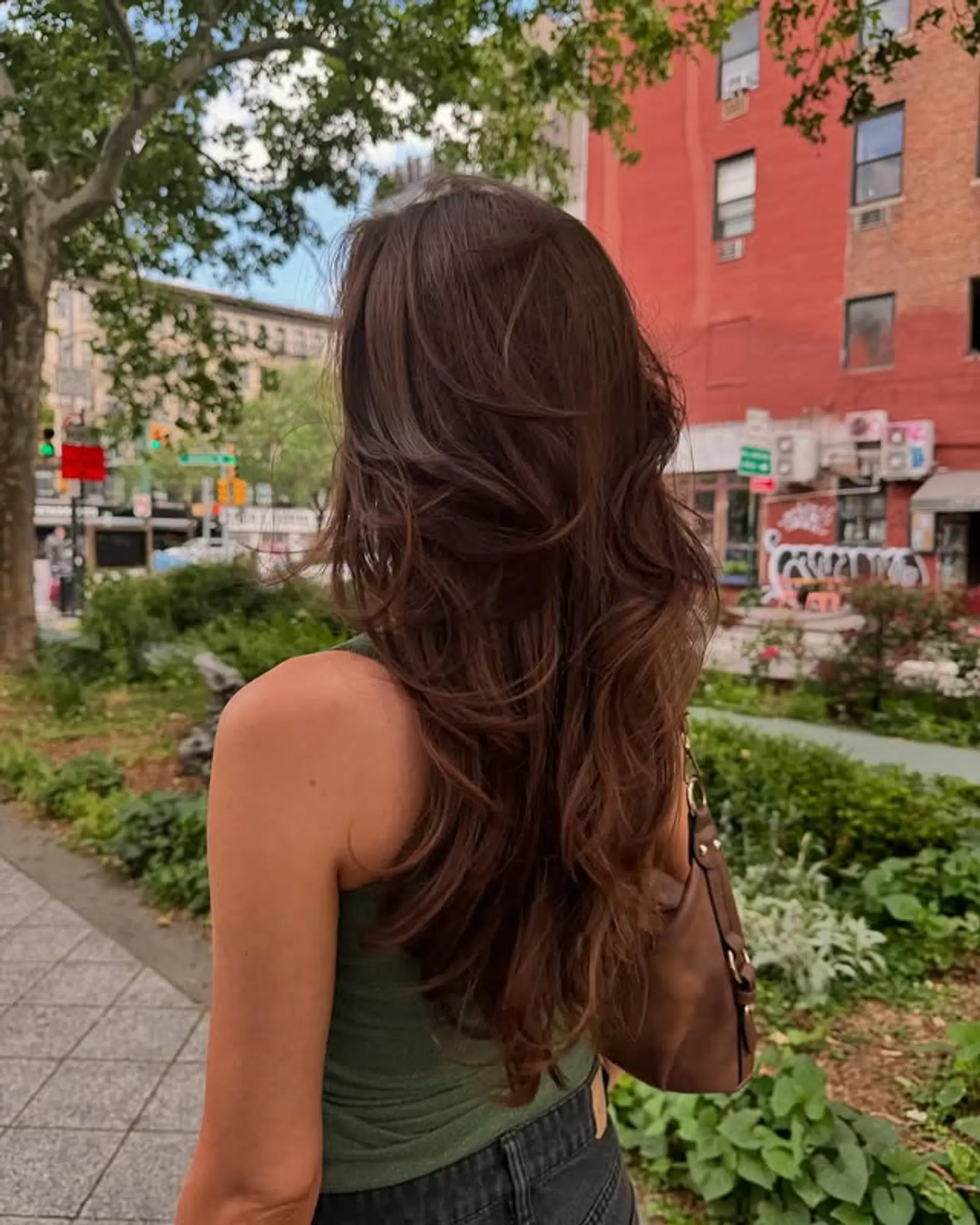 Long, layered haircut with loose waves for an effortless style. 1