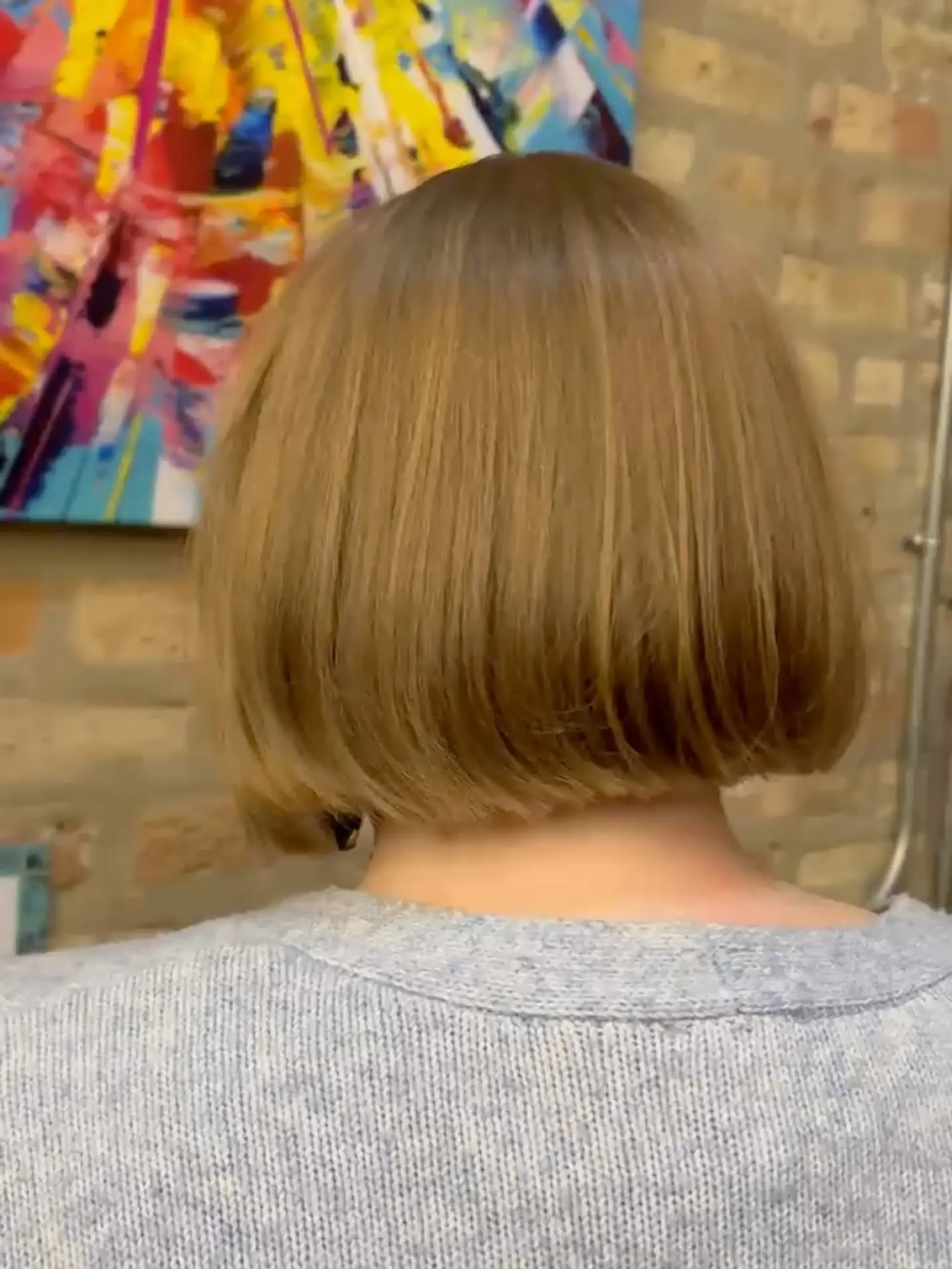 A clean, chin-length blunt bob with subtly beveled ends styled smooth and straight. 1