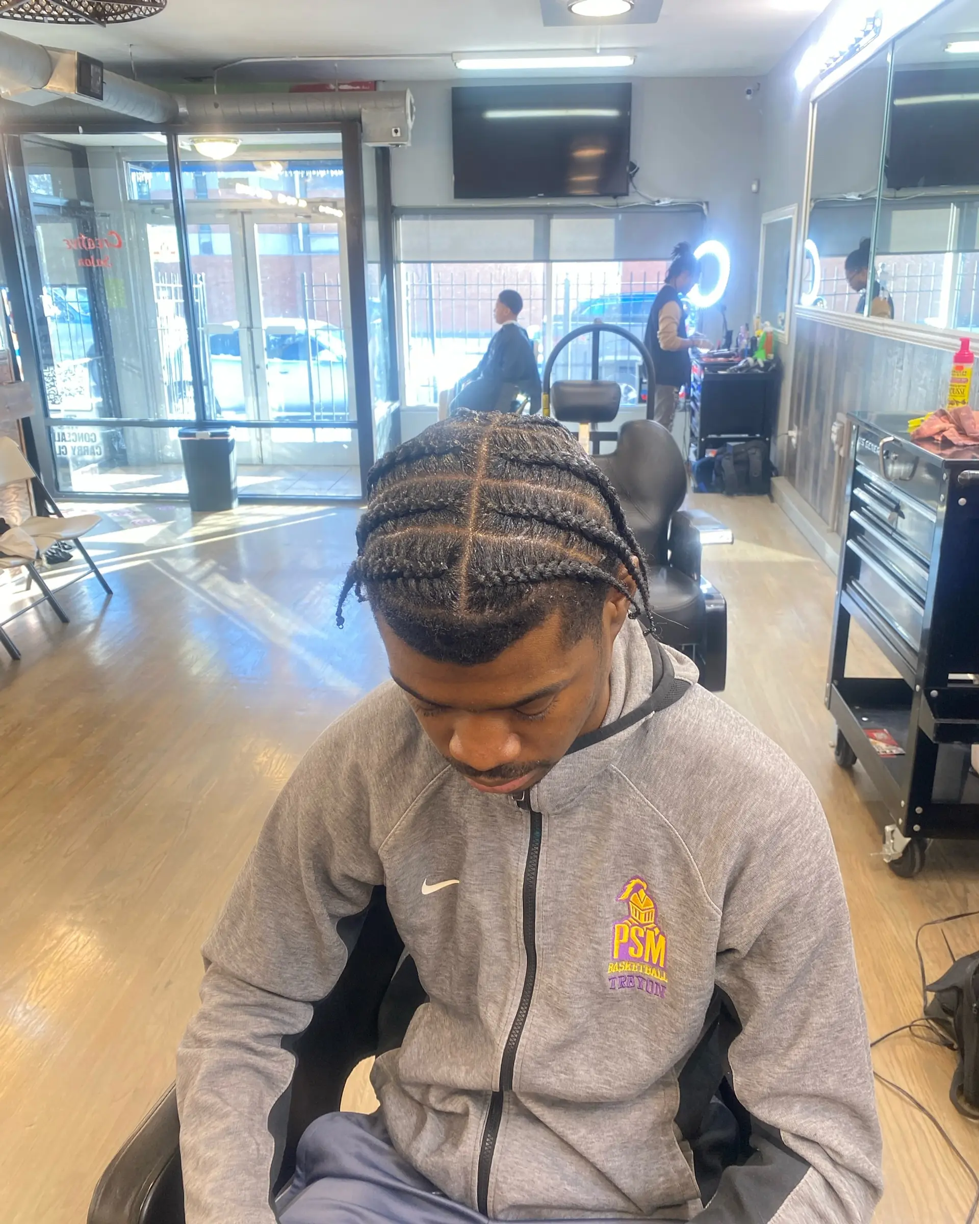 A short braided hairstyle for men, offering a protective and stylish look. 1