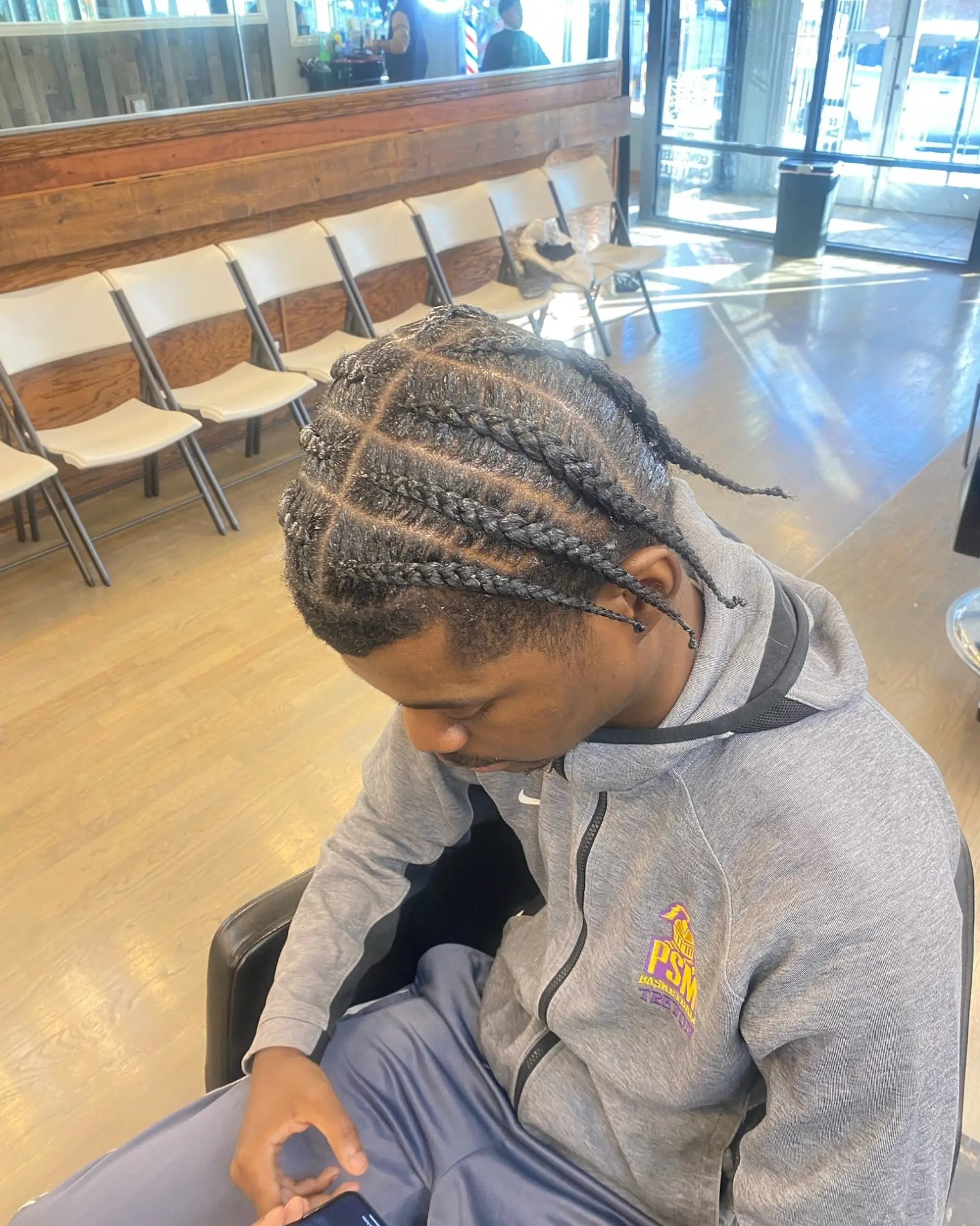 A short braided hairstyle for men, offering a protective and stylish look. 2