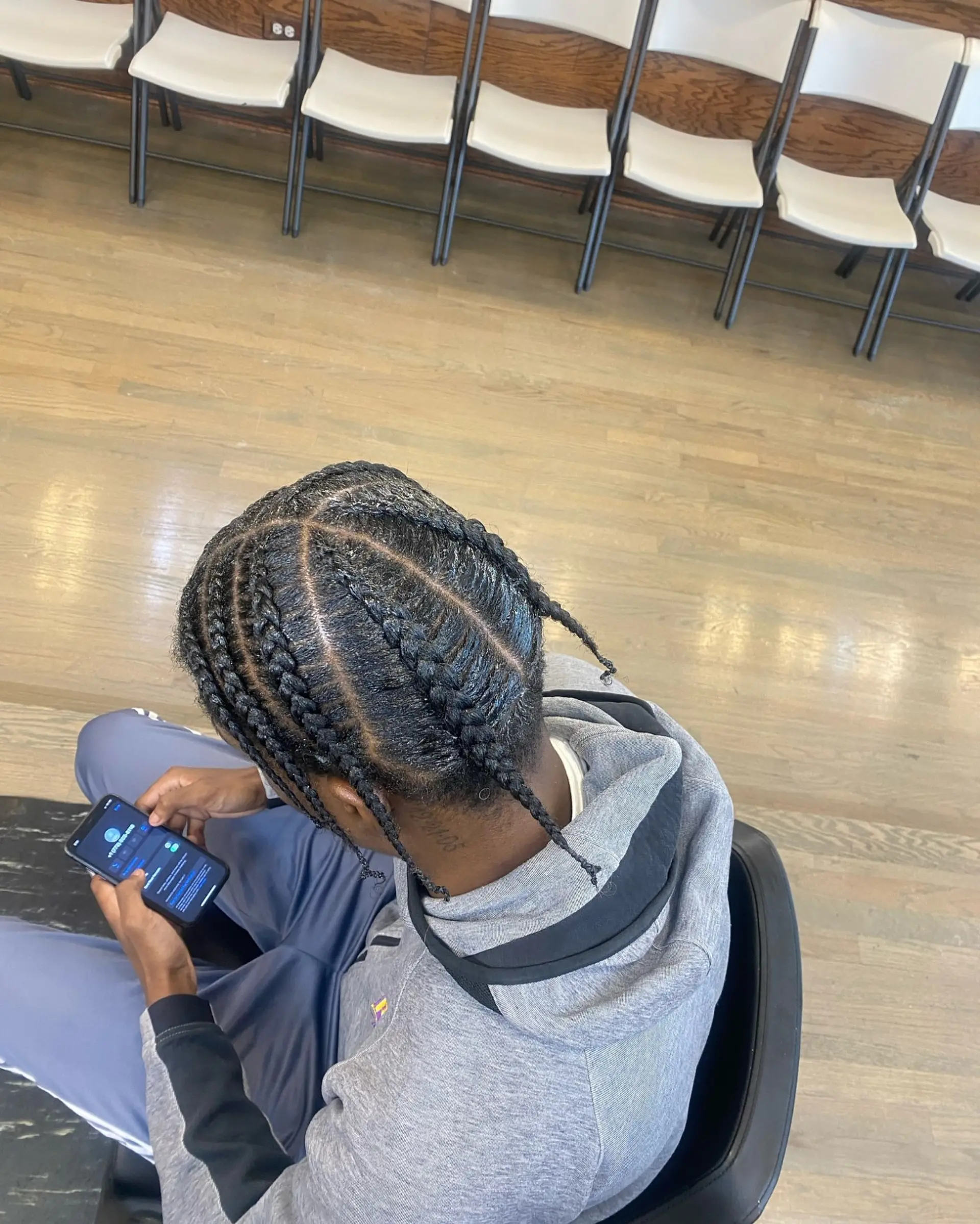 A short braided hairstyle for men, offering a protective and stylish look. 3