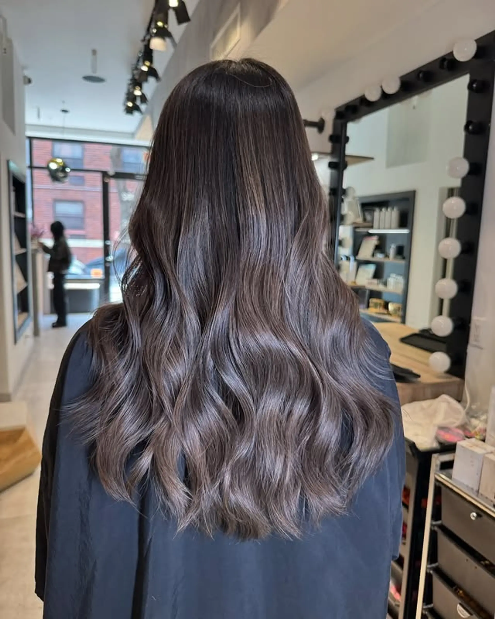 Long, wavy hairstyle with a mocha balayage and effortless waves. 1