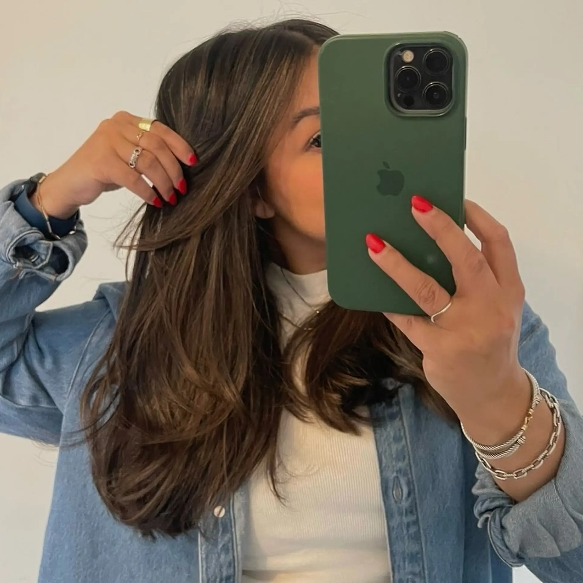 A long, layered haircut styled with a voluminous blowout and face-framing layers. 1