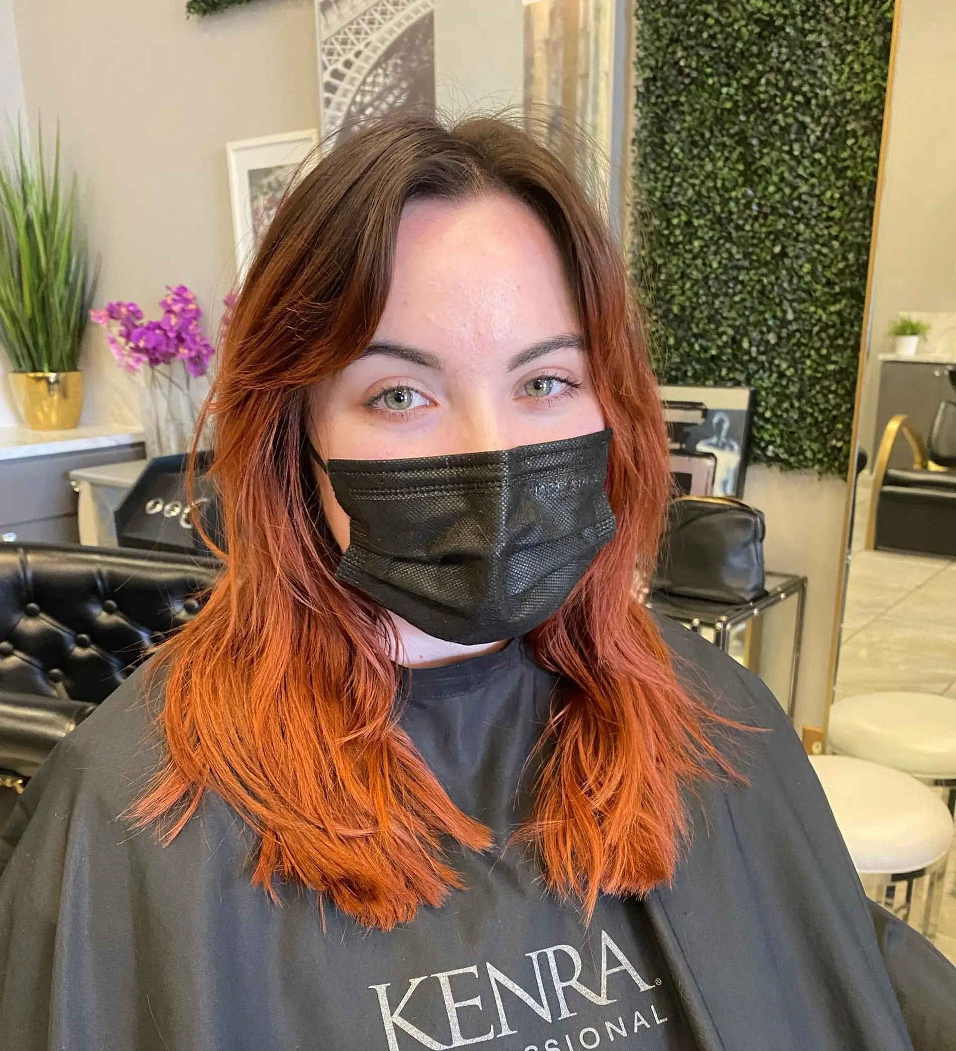 A layered hairstyle with vibrant copper tones and face-framing layers. 1