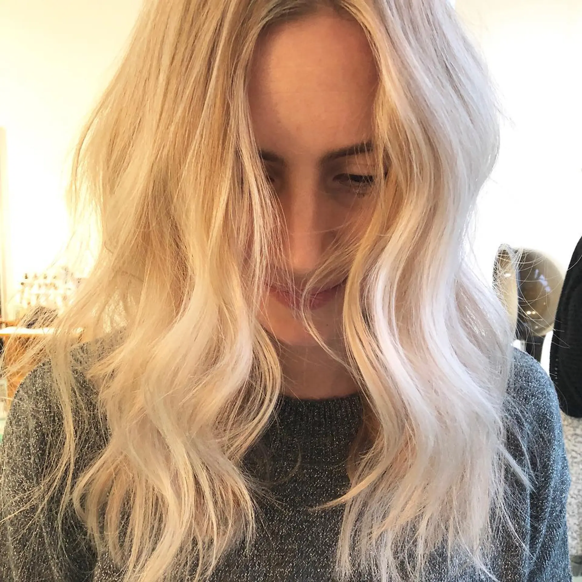 A medium-length textured lob with bright blonde balayage and soft, loose waves. 1