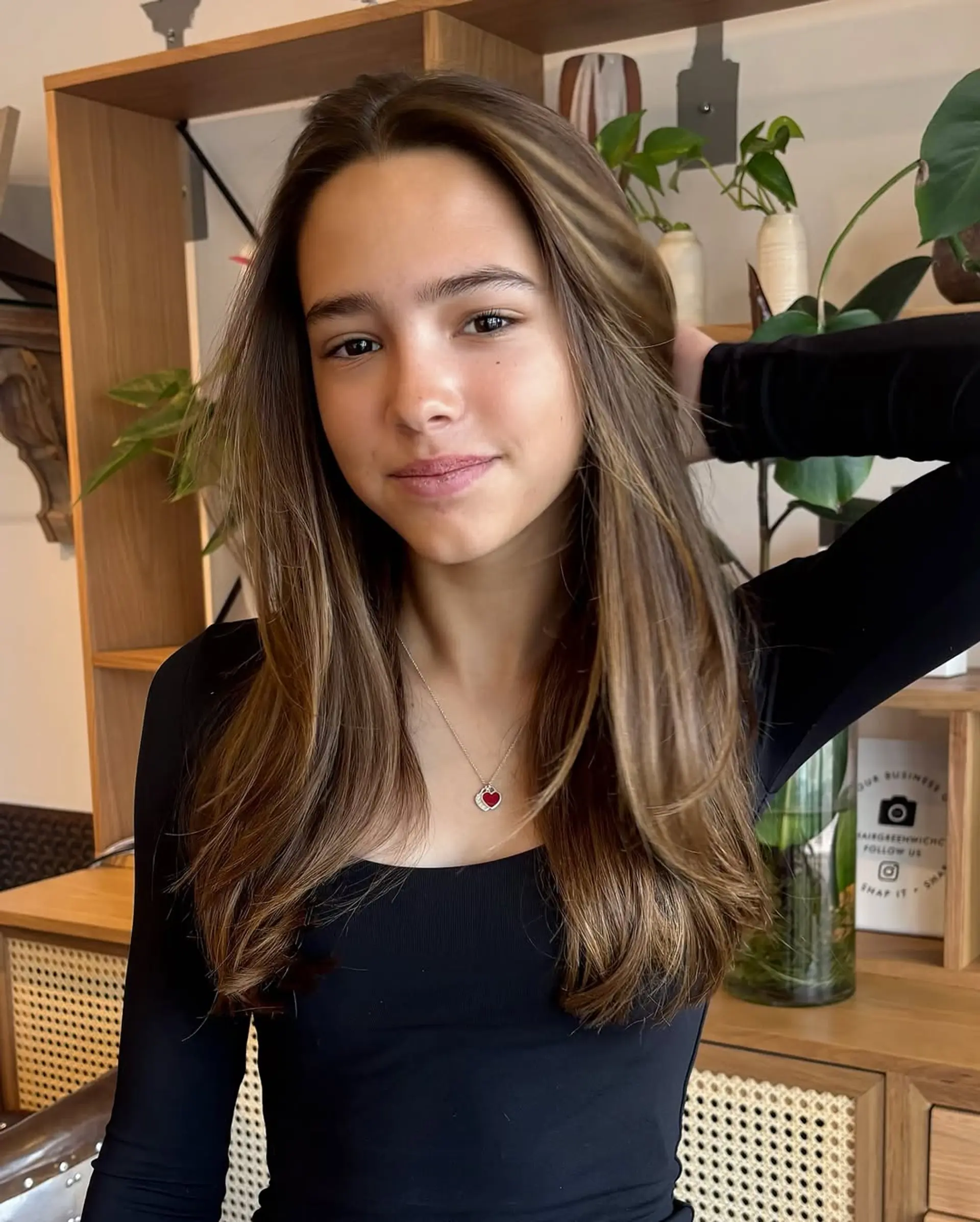 A long, layered hairstyle with face-framing layers and a subtle bronde balayage. 2