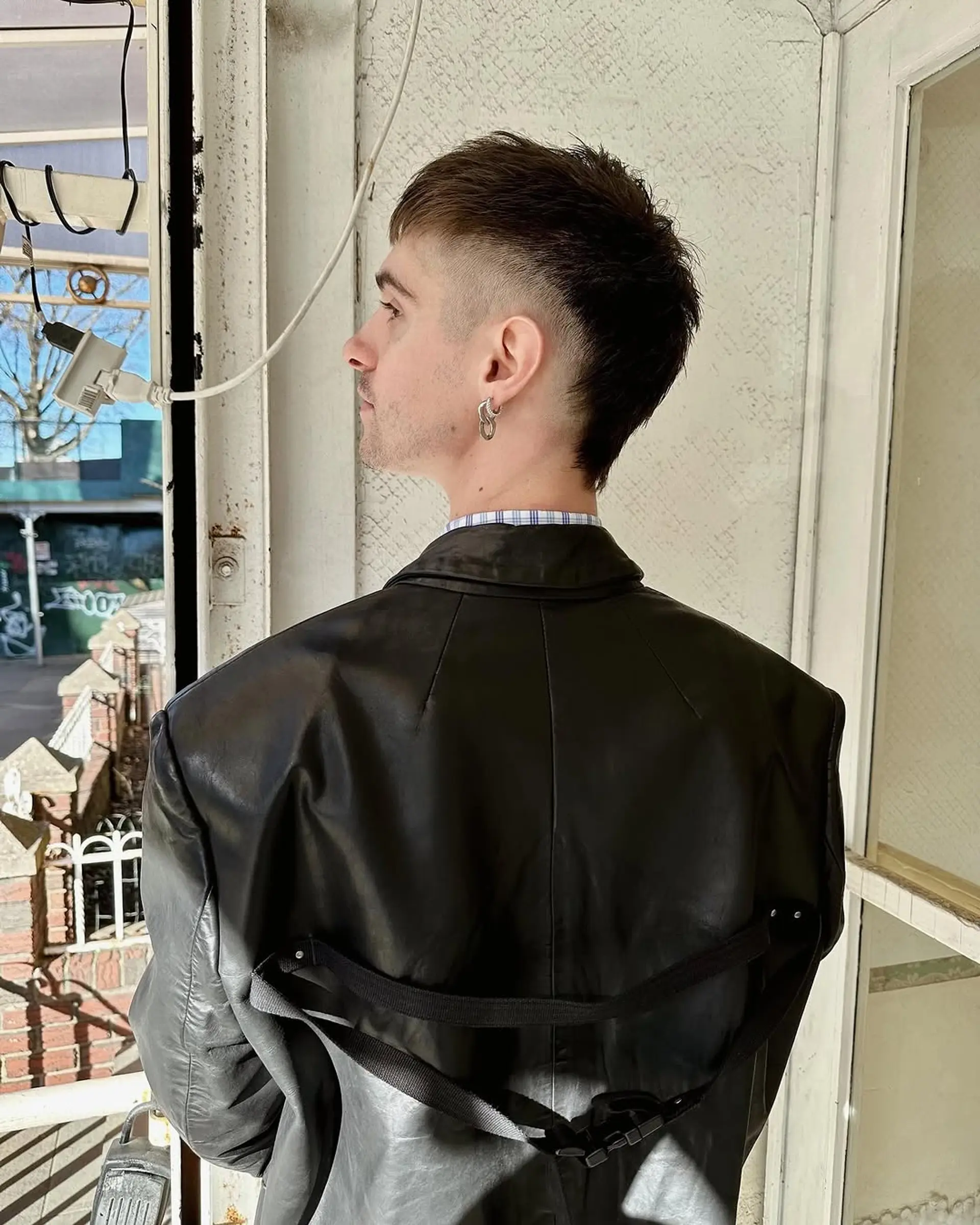 A burst fade with a textured top and sleek, tapered sides, creating a bold and contemporary look. 1