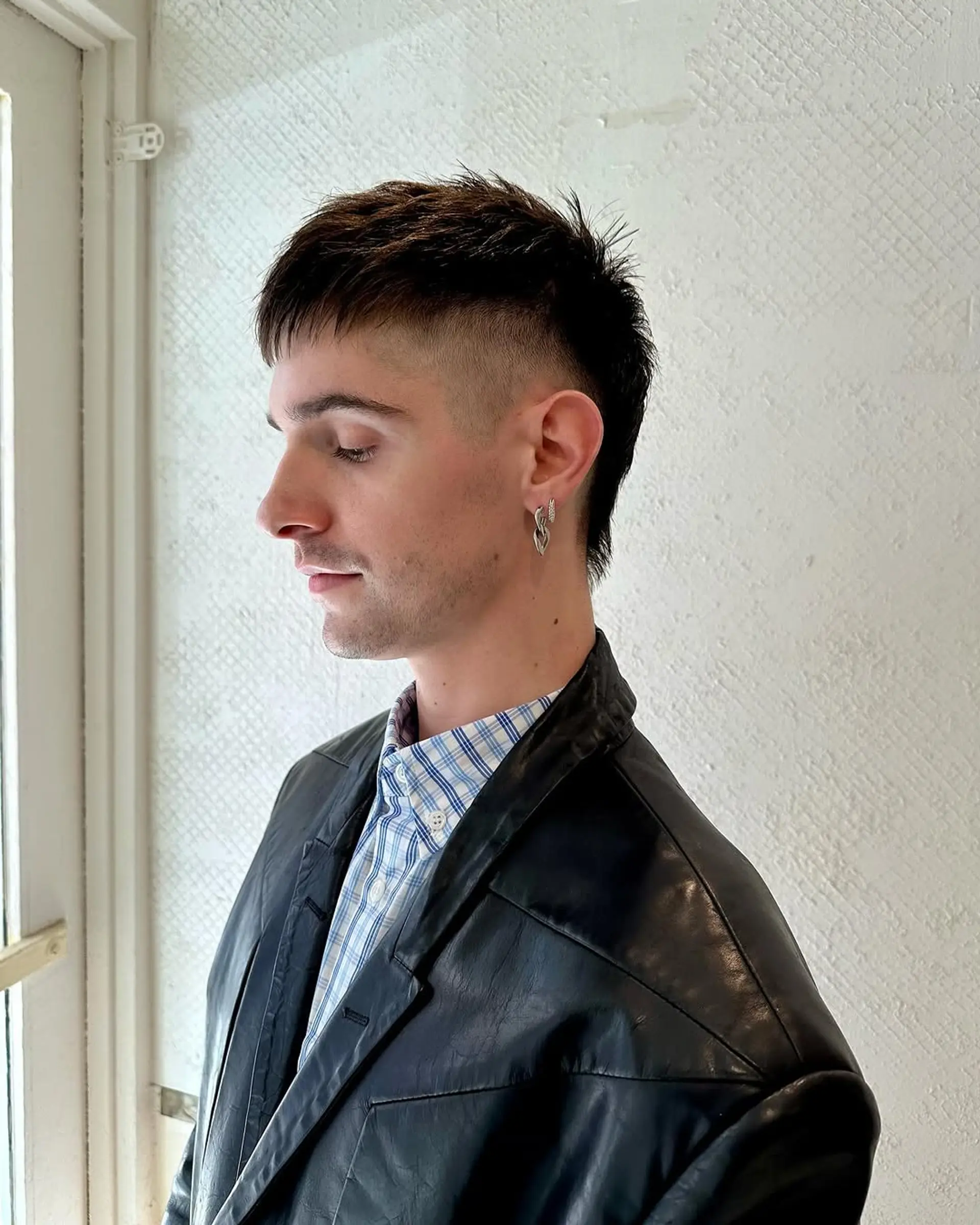A burst fade with a textured top and sleek, tapered sides, creating a bold and contemporary look. 3