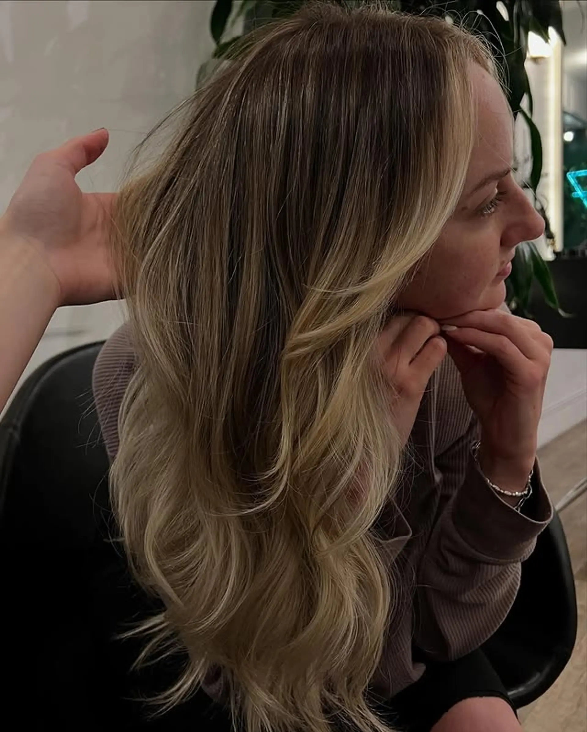 Long layered cut with face-framing layers and a soft wavy style. 1