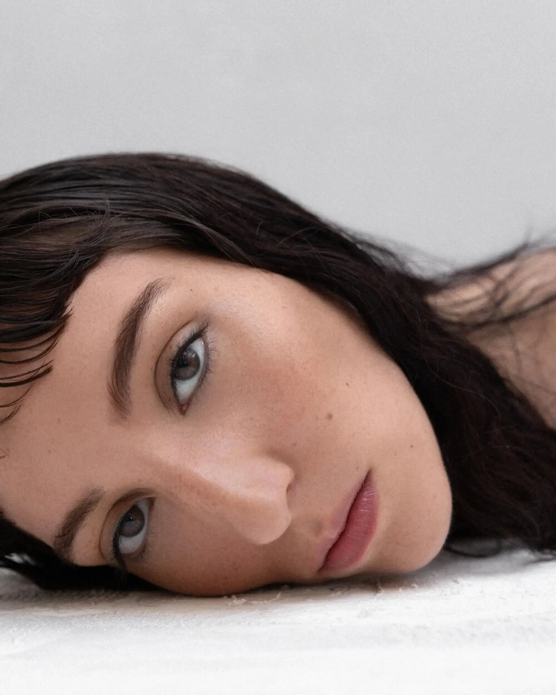 Medium-length wavy hairstyle with a wet, glossy texture. Features side-swept bangs and naturally styled waves in a sleek black color. Bangs by @takeohair 2