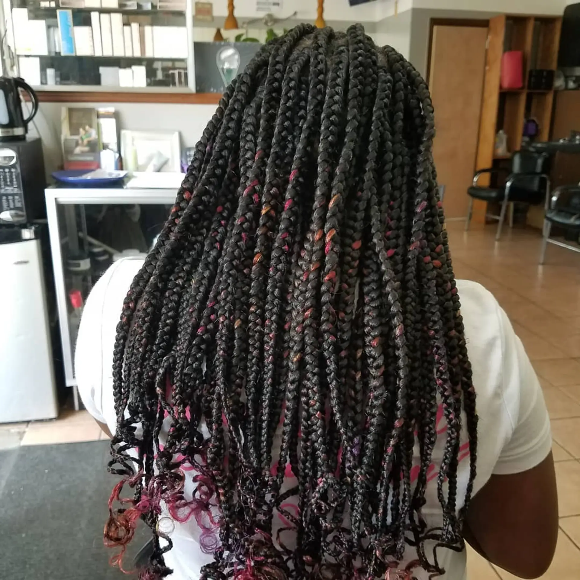 Long black box braids with colorful highlights and curly ends. 1