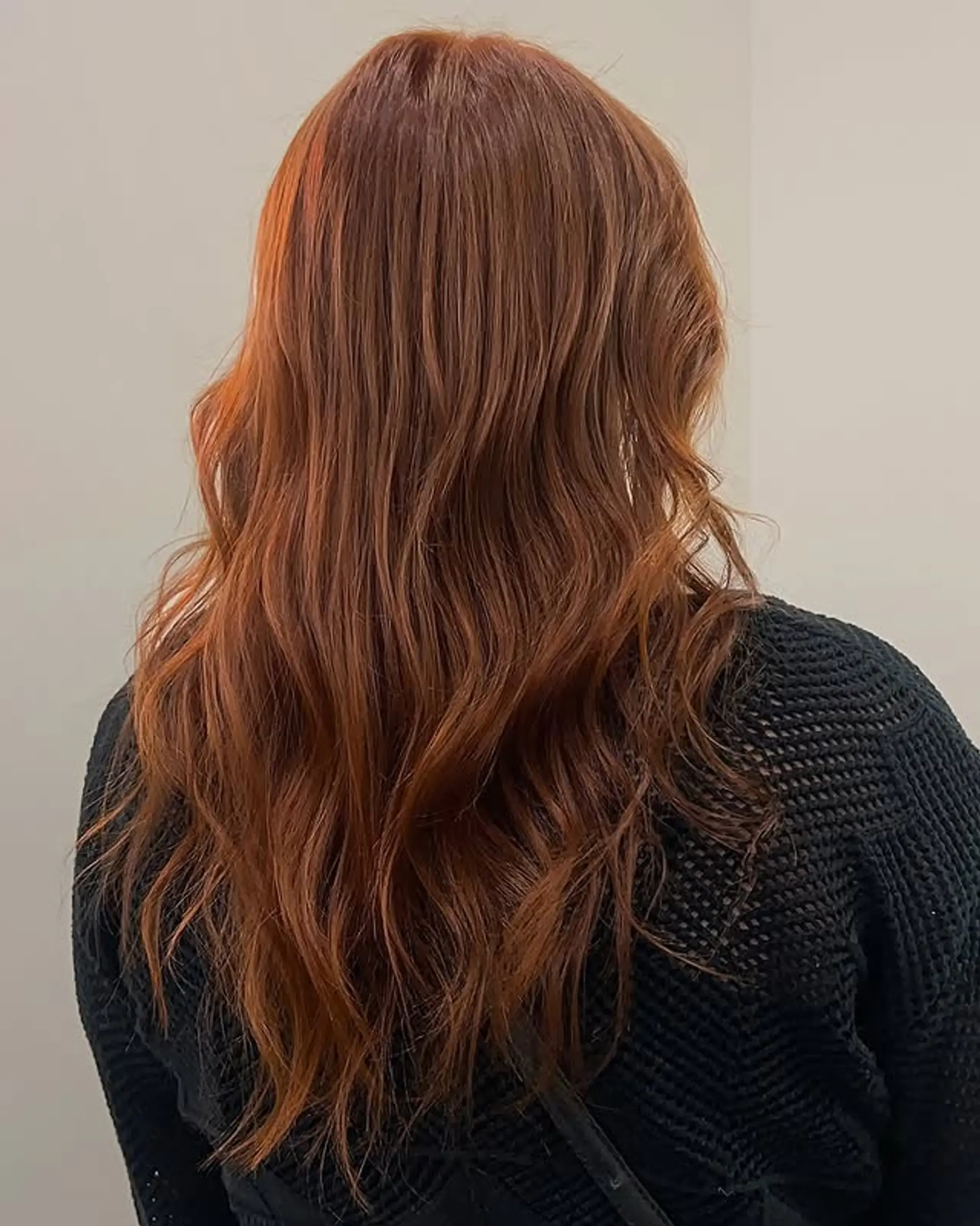 Long layered wavy hairstyle with a vibrant copper color. 1