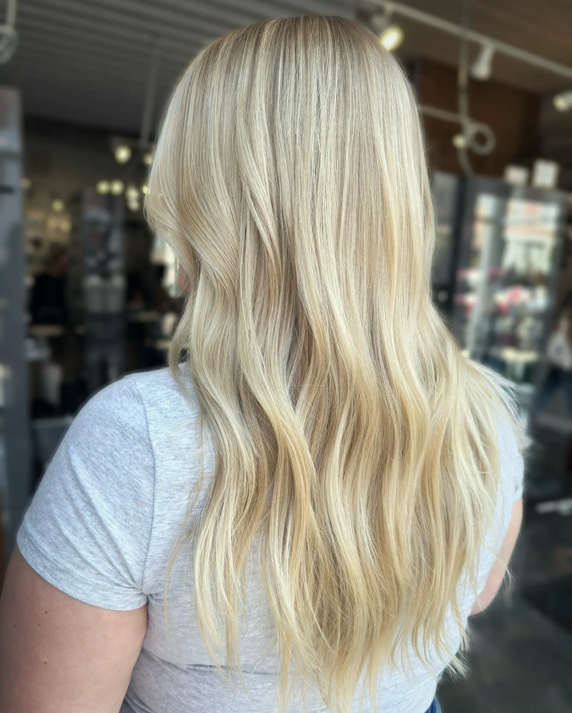 This hairstyle features long, wavy icy blonde hair. 1