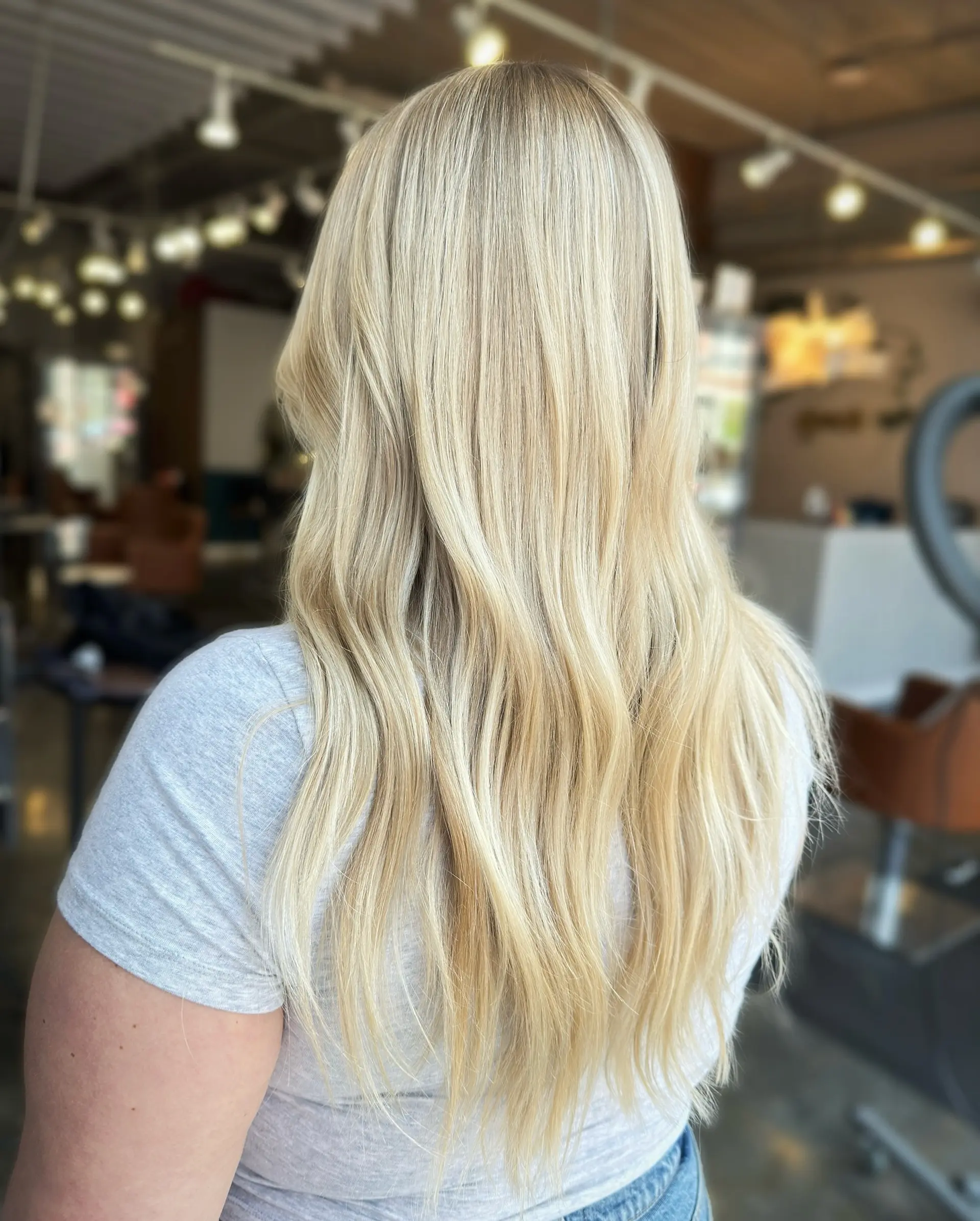 This hairstyle features long, wavy icy blonde hair. 2