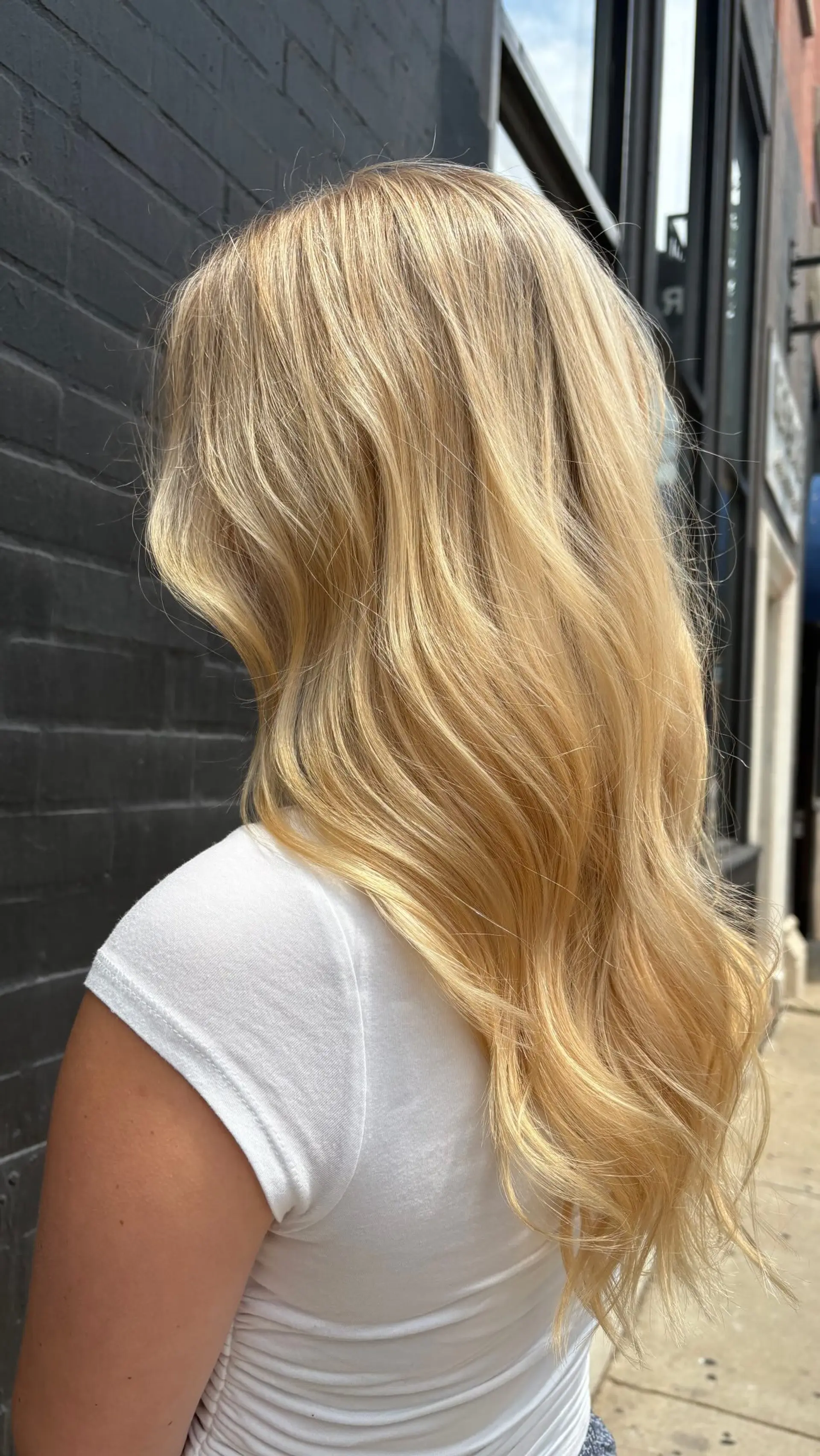 Long golden blonde hair styled in soft, flowing loose waves with multidimensional warm tones. 1