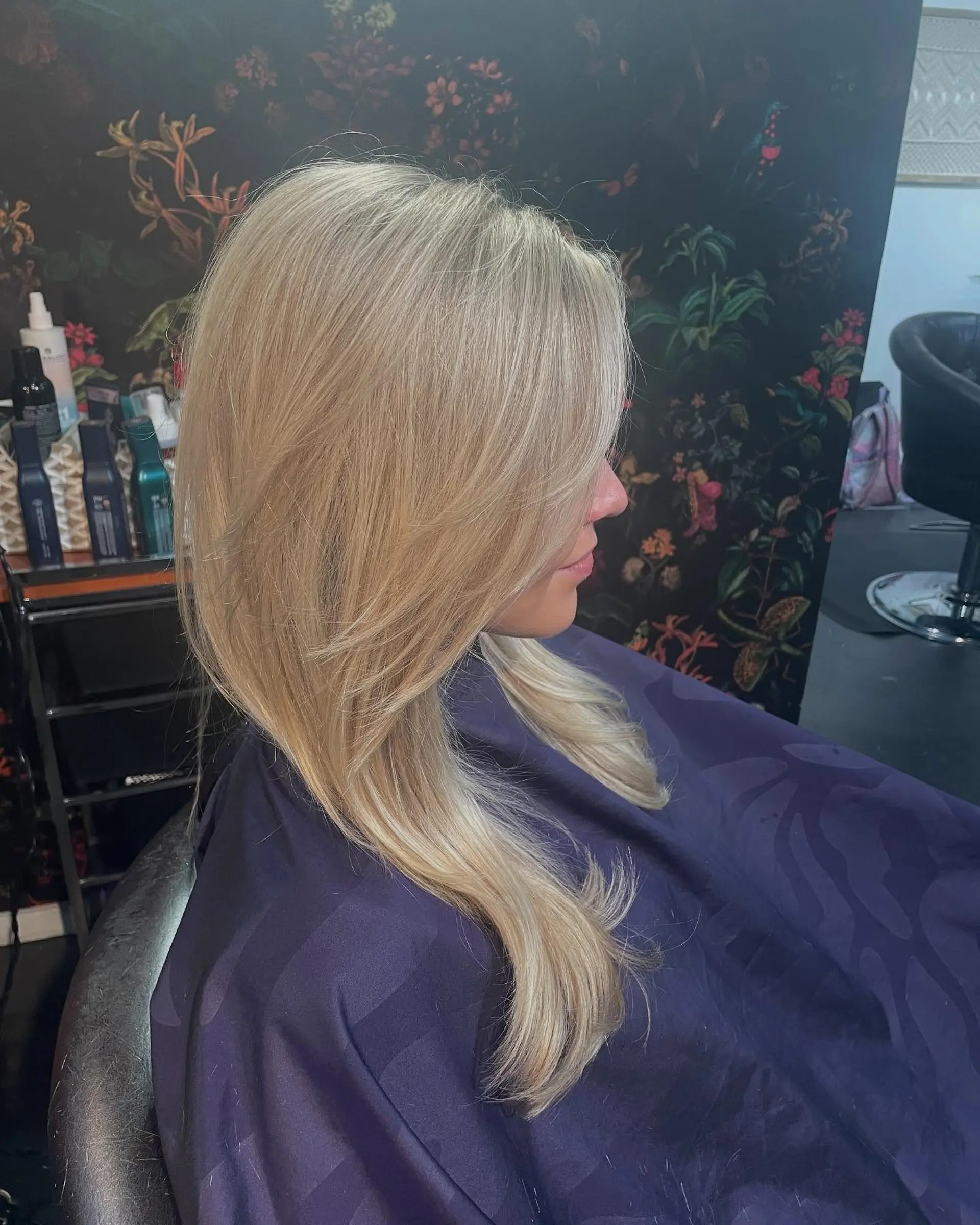 A seamless light blonde full highlight with long, sweeping face-framing layers and a smooth finish. 1