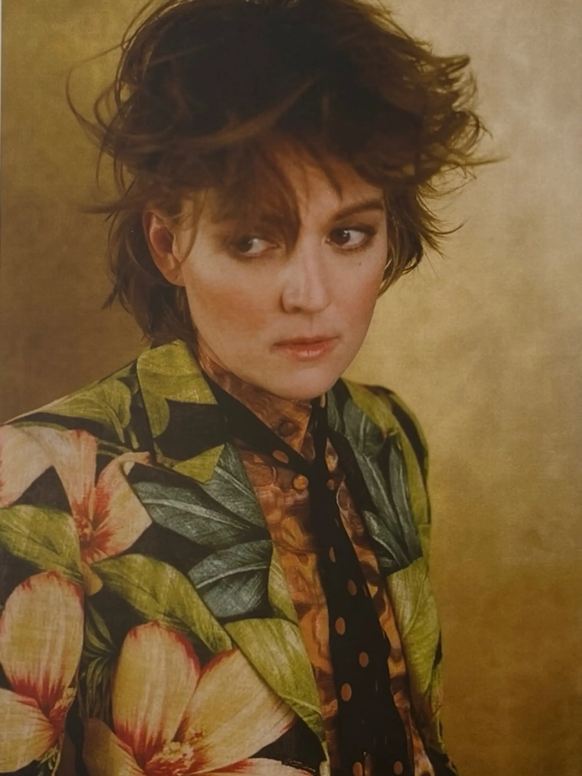 A short, heavily textured shag cut featuring voluminous, piecey layers on top and wispy fringe across the forehead. 1