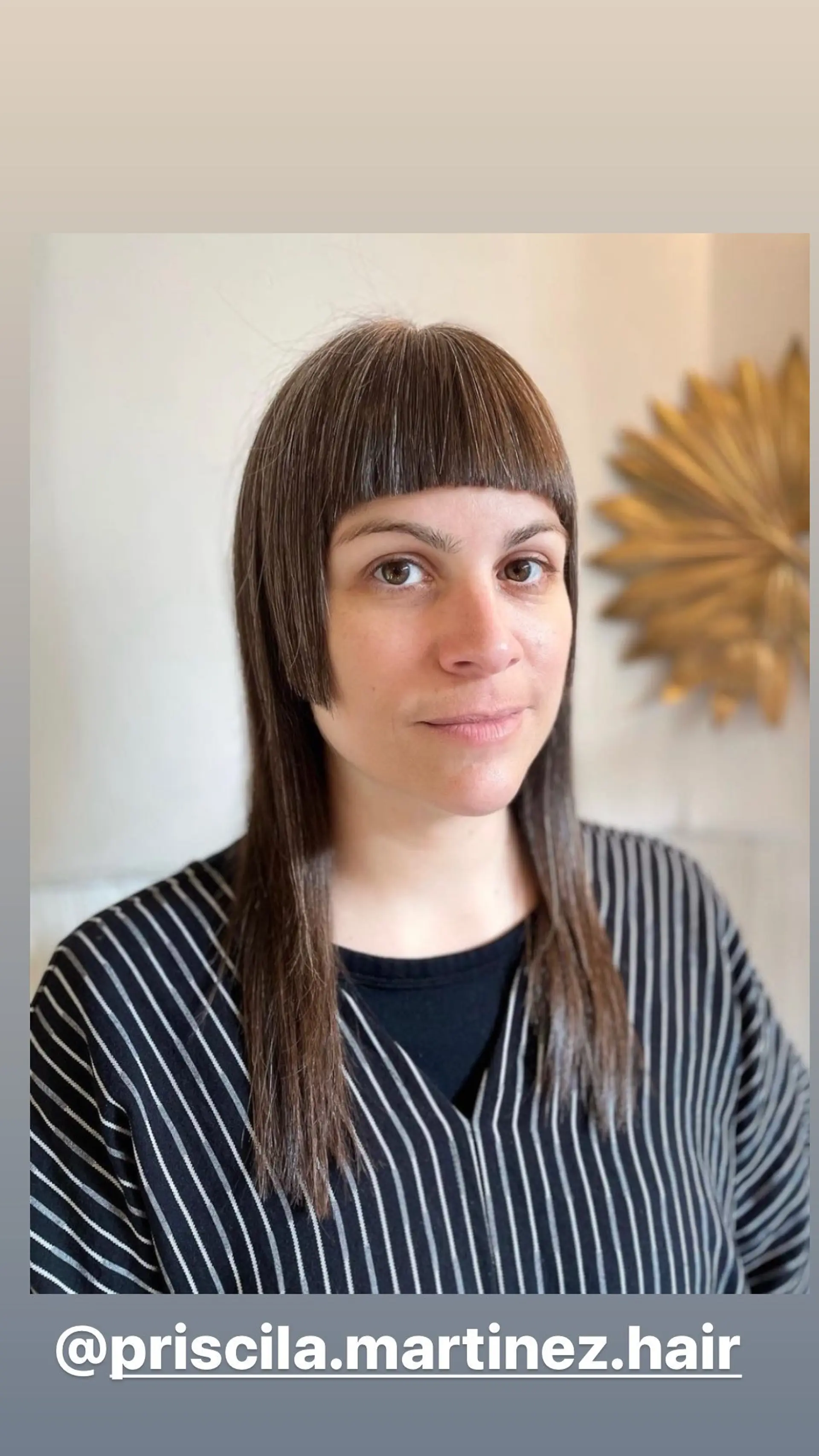 A modern shag haircut featuring blunt bangs and layered strands. 1