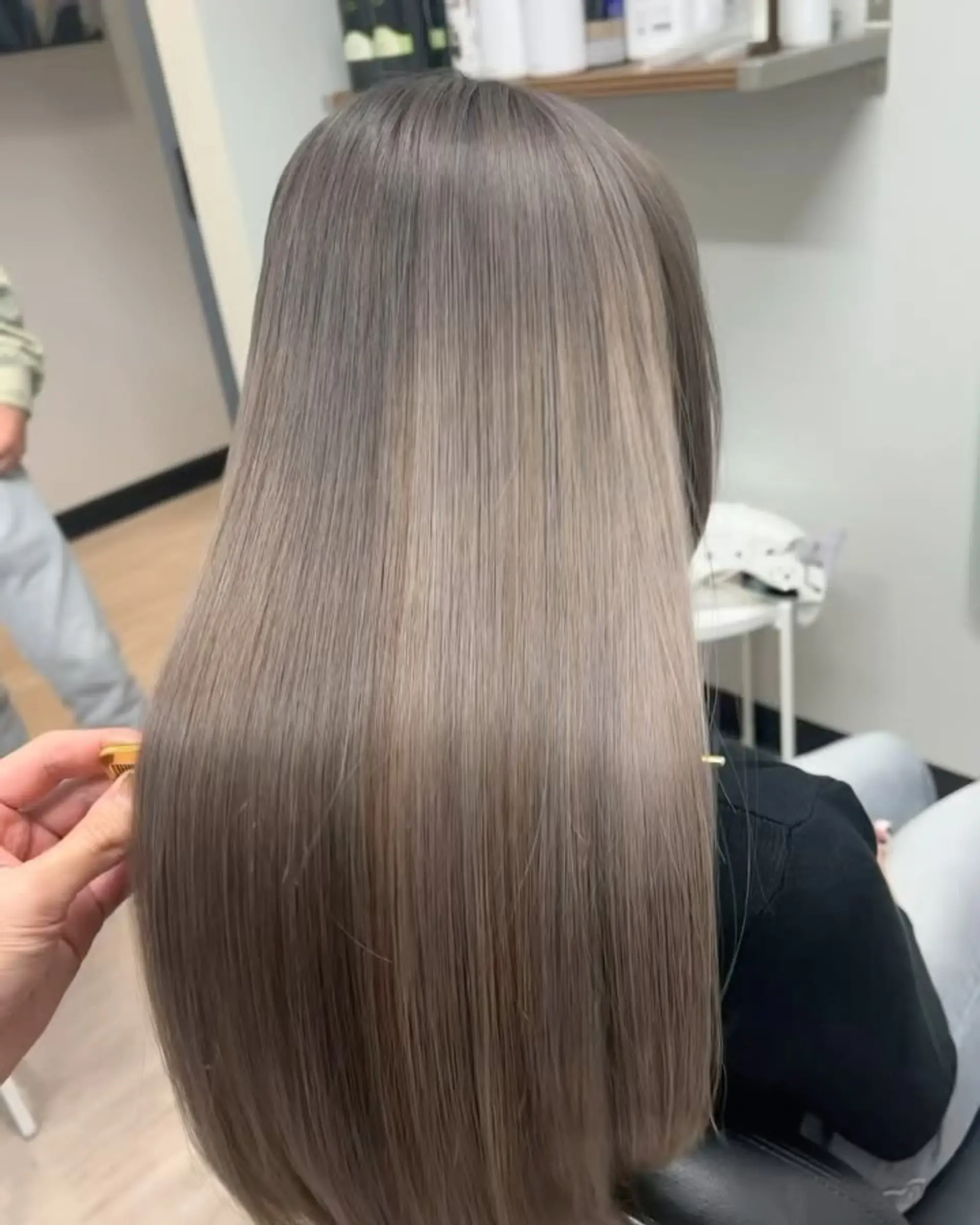 Ultra-sleek, pin-straight long hair with a smooth, glossy finish in an ash beige tone. 1