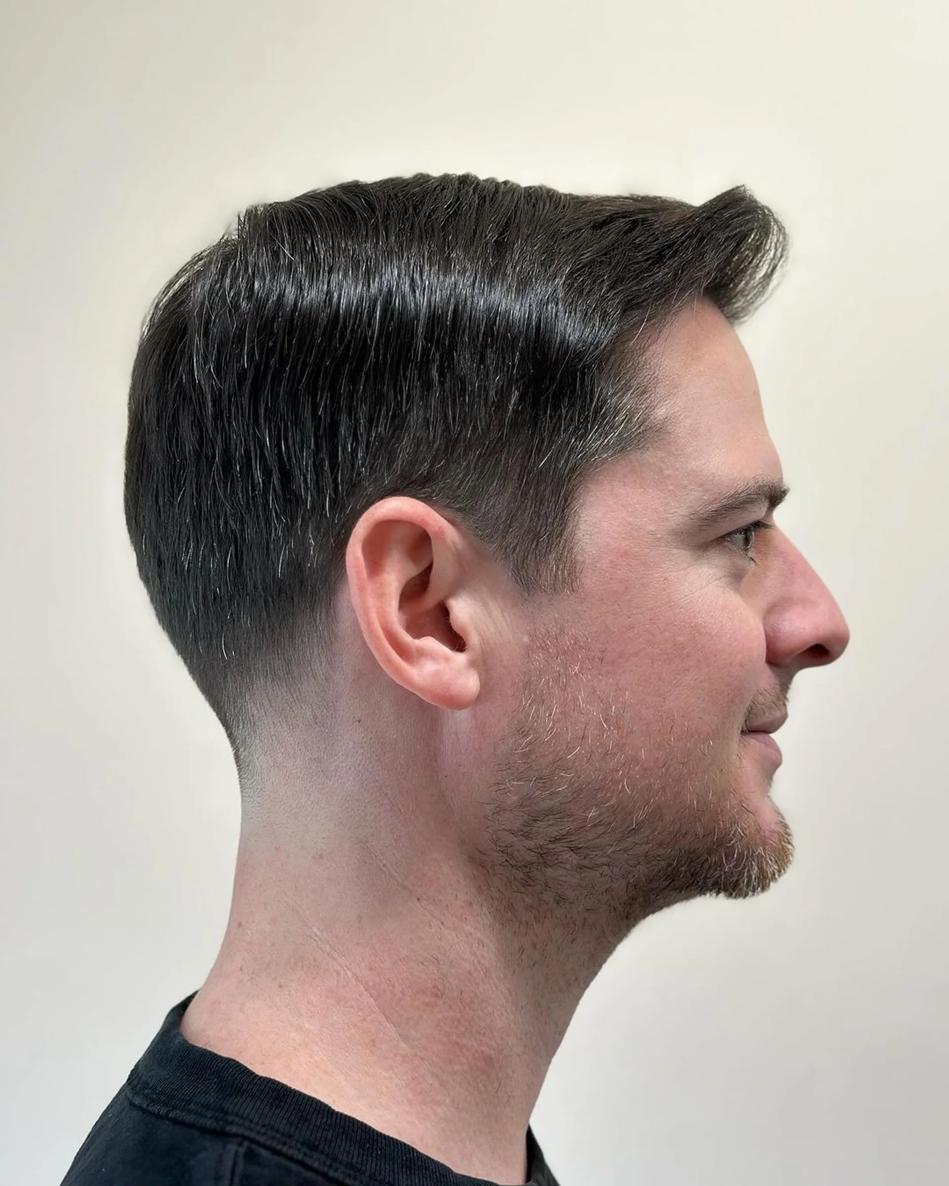 Sleek men's side-swept haircut with subtle side part and soft taper, styled with volume at the crown, perfect for the modern NYC gentleman. - Preview 2