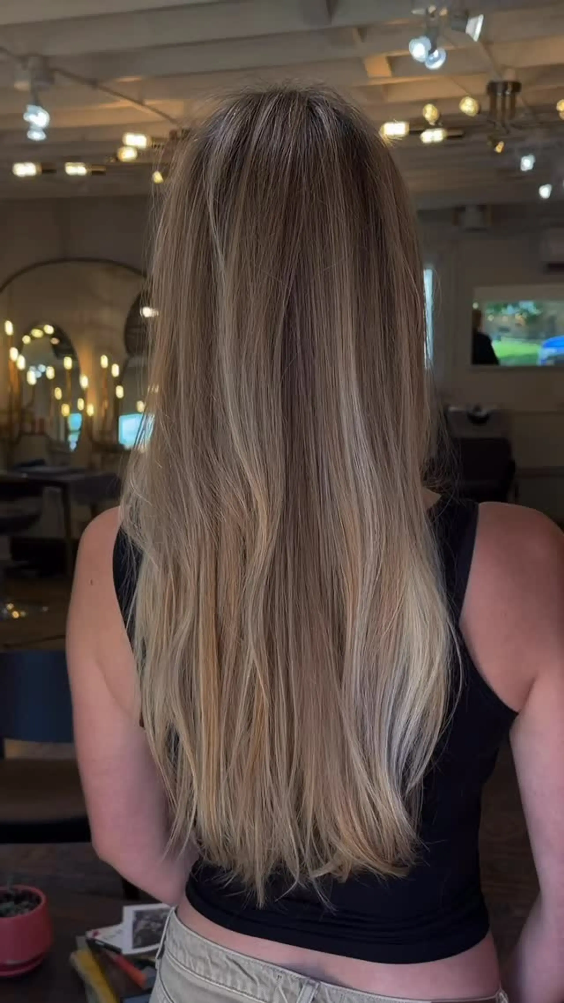 Long, smooth hair featuring finely blended, sun-kissed blonde highlights over a natural light brown base. 1