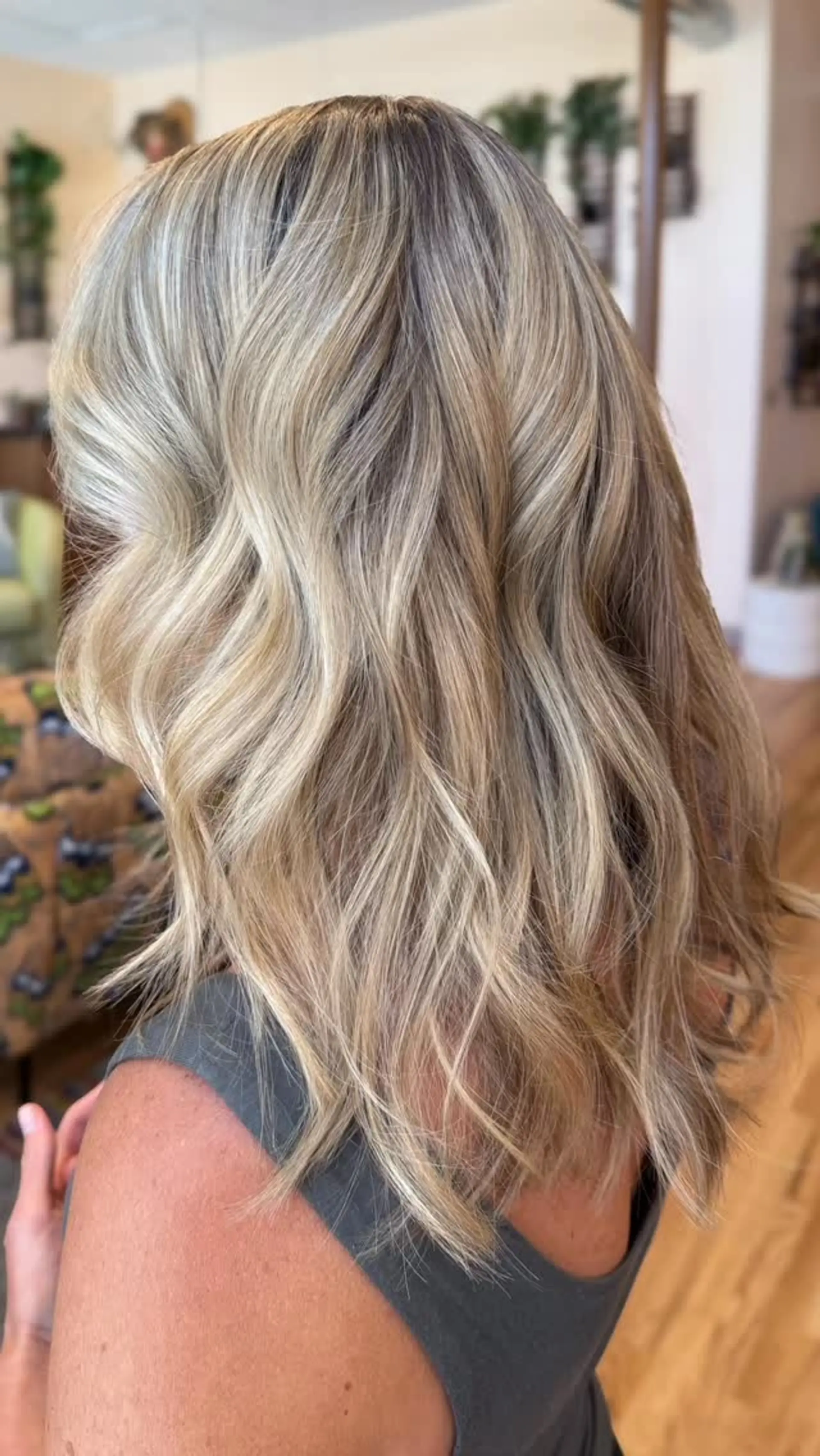 Medium-length dimensional blonde hair styled in soft, loose waves with bright face-framing ribbons. 1