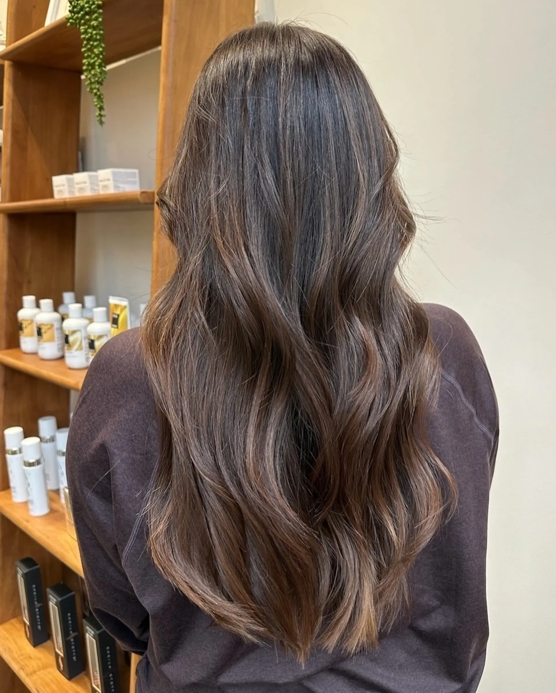 Long, wavy hairstyle with layered ends and balayage highlights. 1