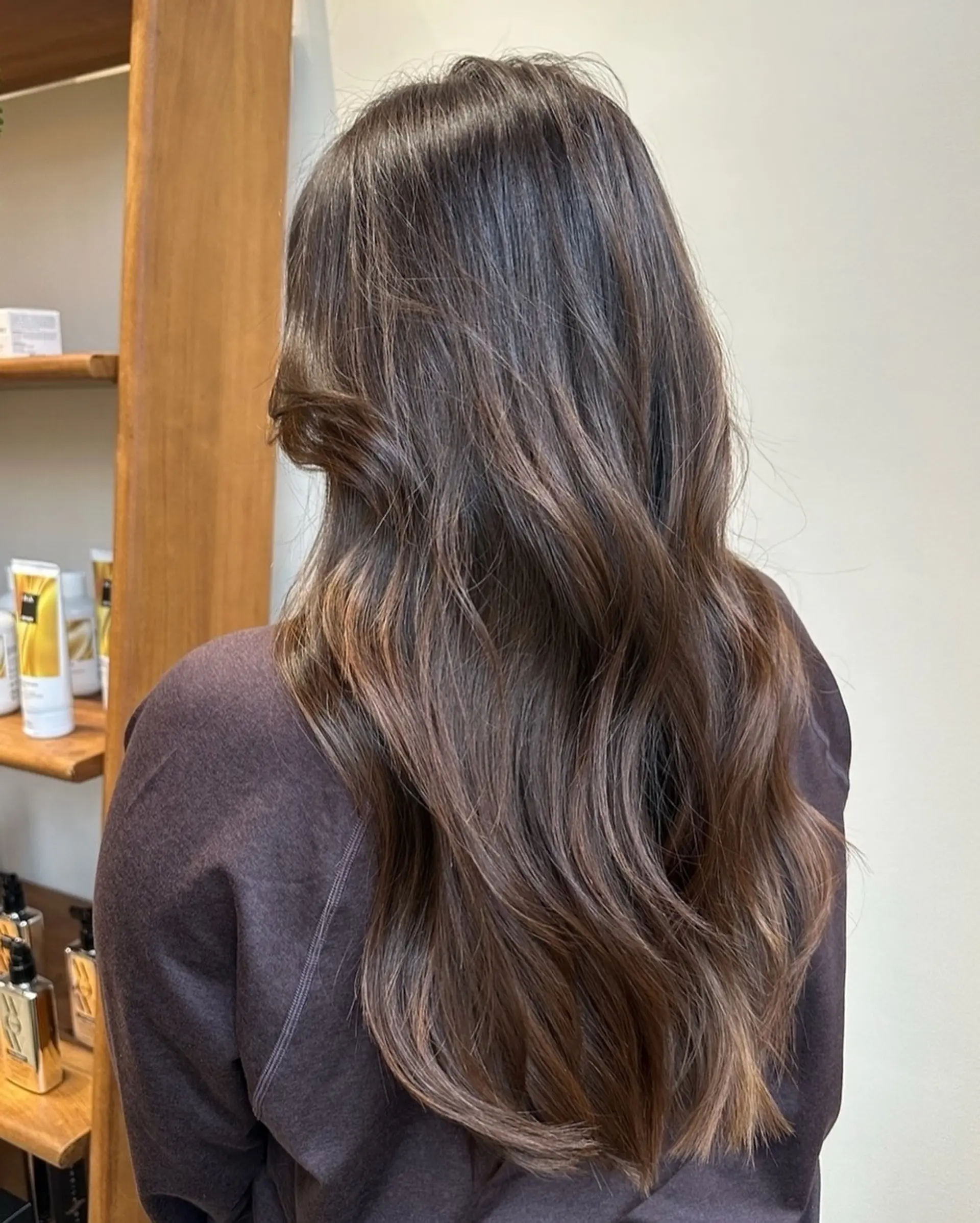 Long, wavy hairstyle with layered ends and balayage highlights. 2