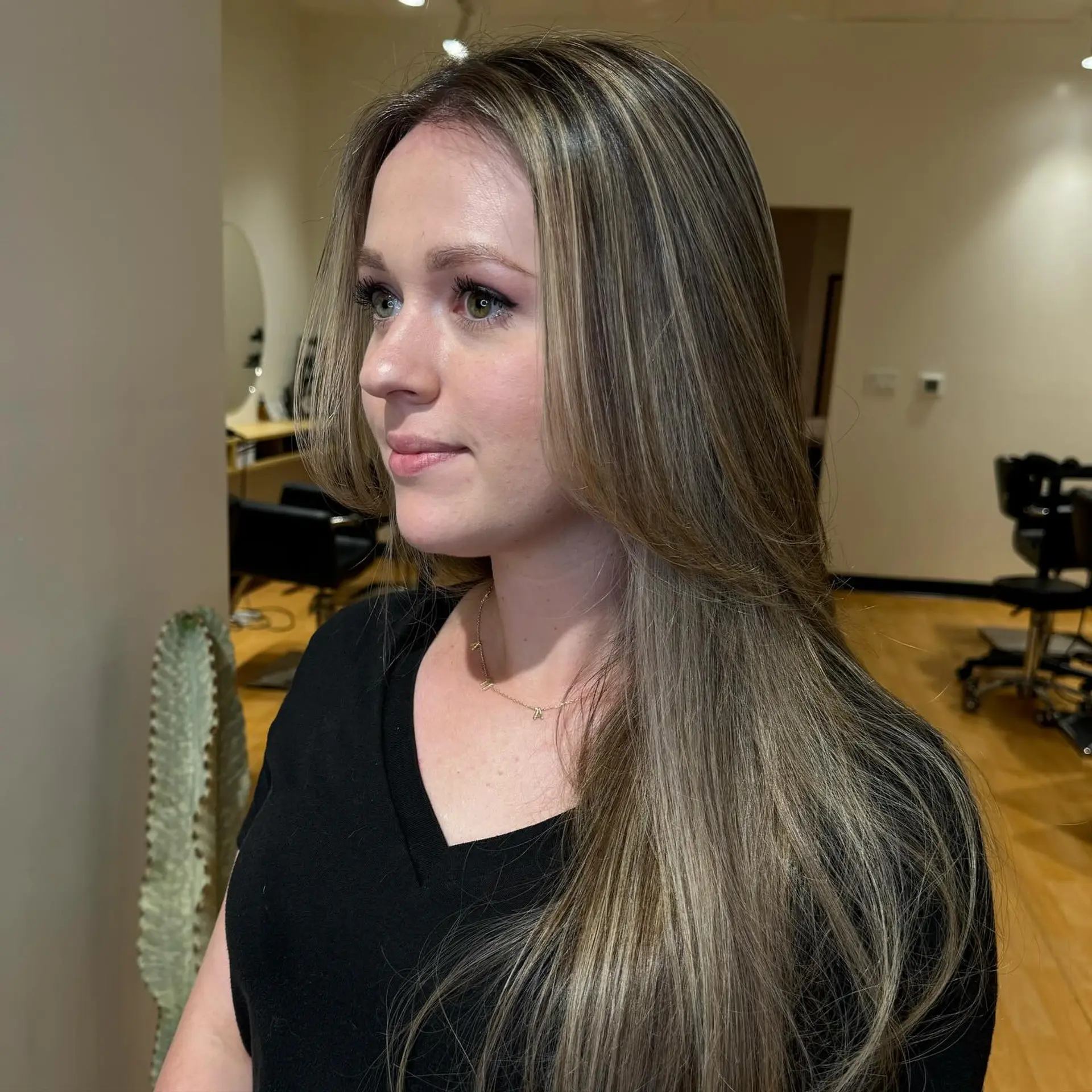 Long, straight hair featuring finely woven cool ash blonde highlights with soft face-framing layers. 1