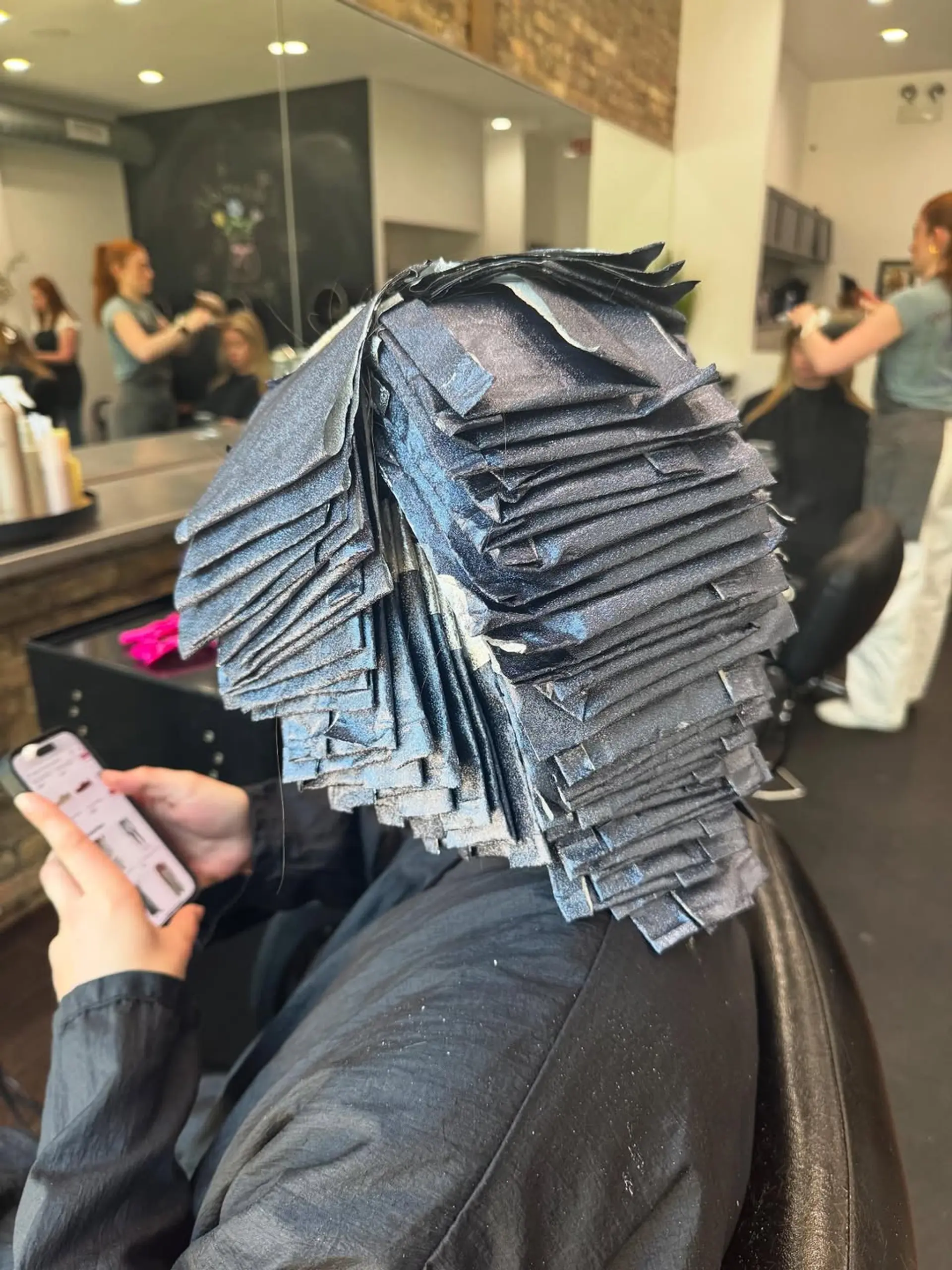 A sleek, short layered bob with a vibrant split-dye or multi-tonal color application featuring bold shades of fuchsia, hot pink, and magenta. 3