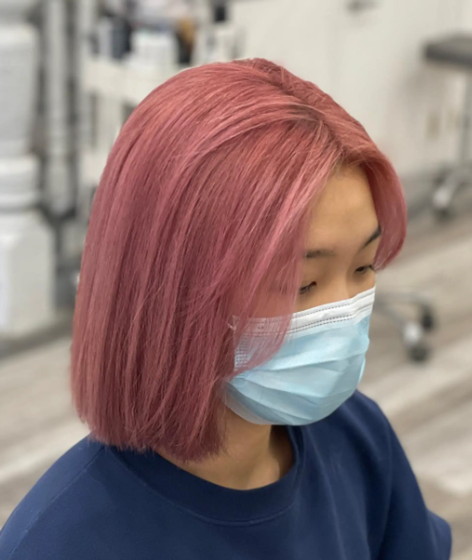 A sleek, straight medium-length bob dyed in a soft, pastel pink hue. 1