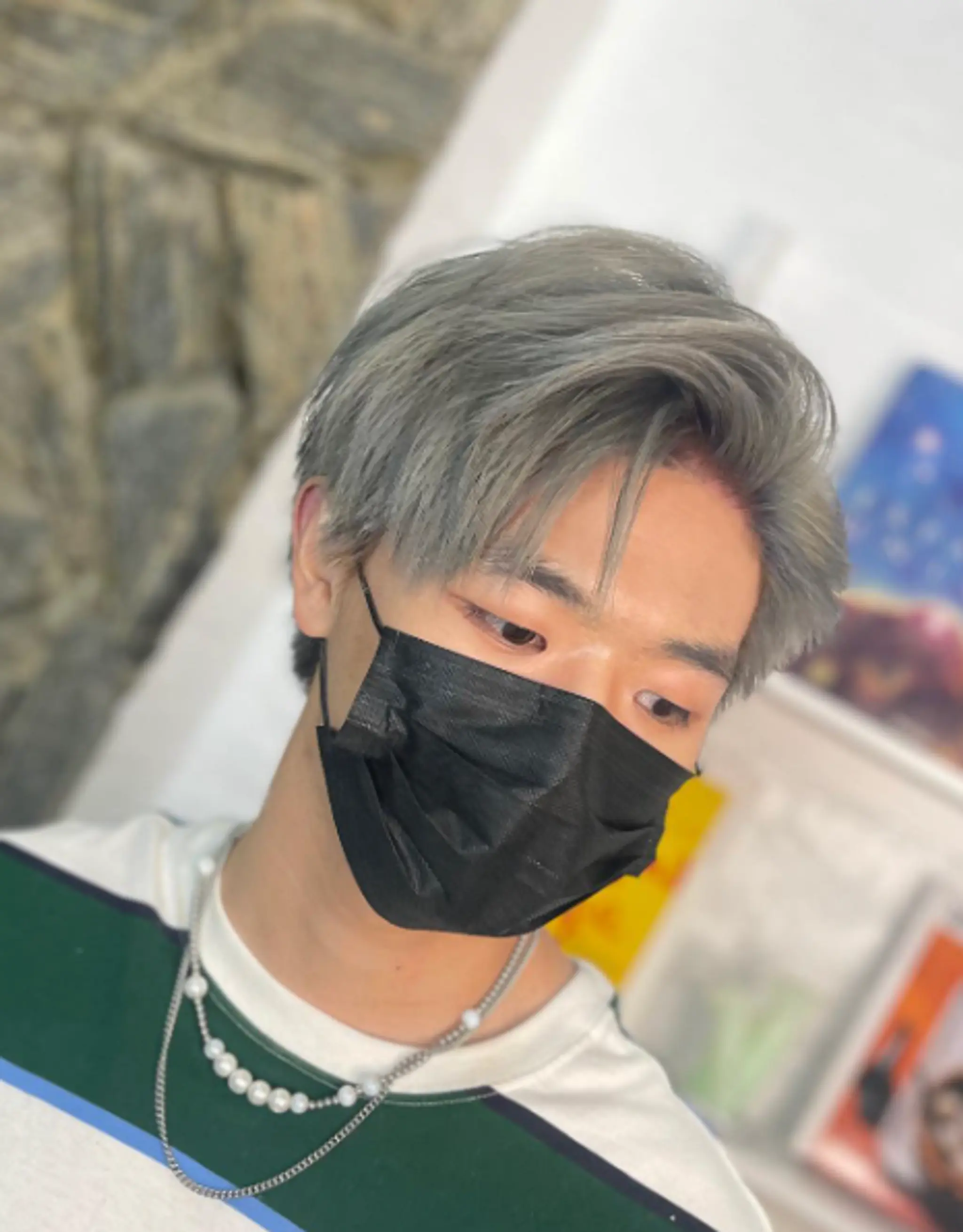 Short, straight hair with side-swept, layered texture in a trendy silver color.