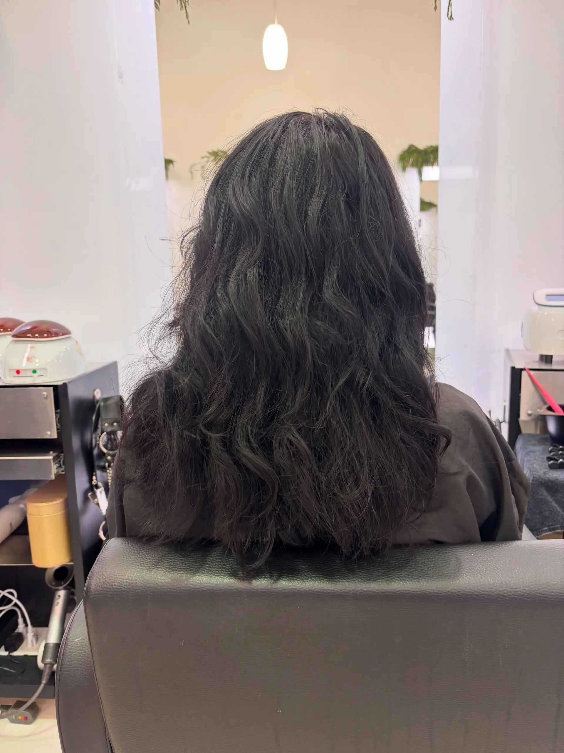 Medium-length dark wavy hair with natural texture and soft volume. 1