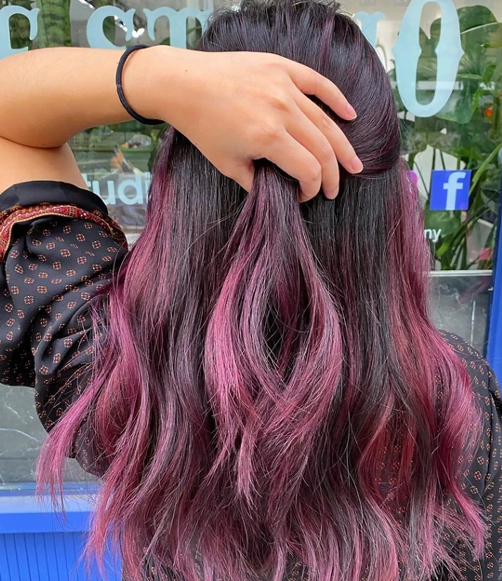 Medium-length wavy hair with a layered cut, featuring a dip-dye or balayage technique with black and magenta colors. 1