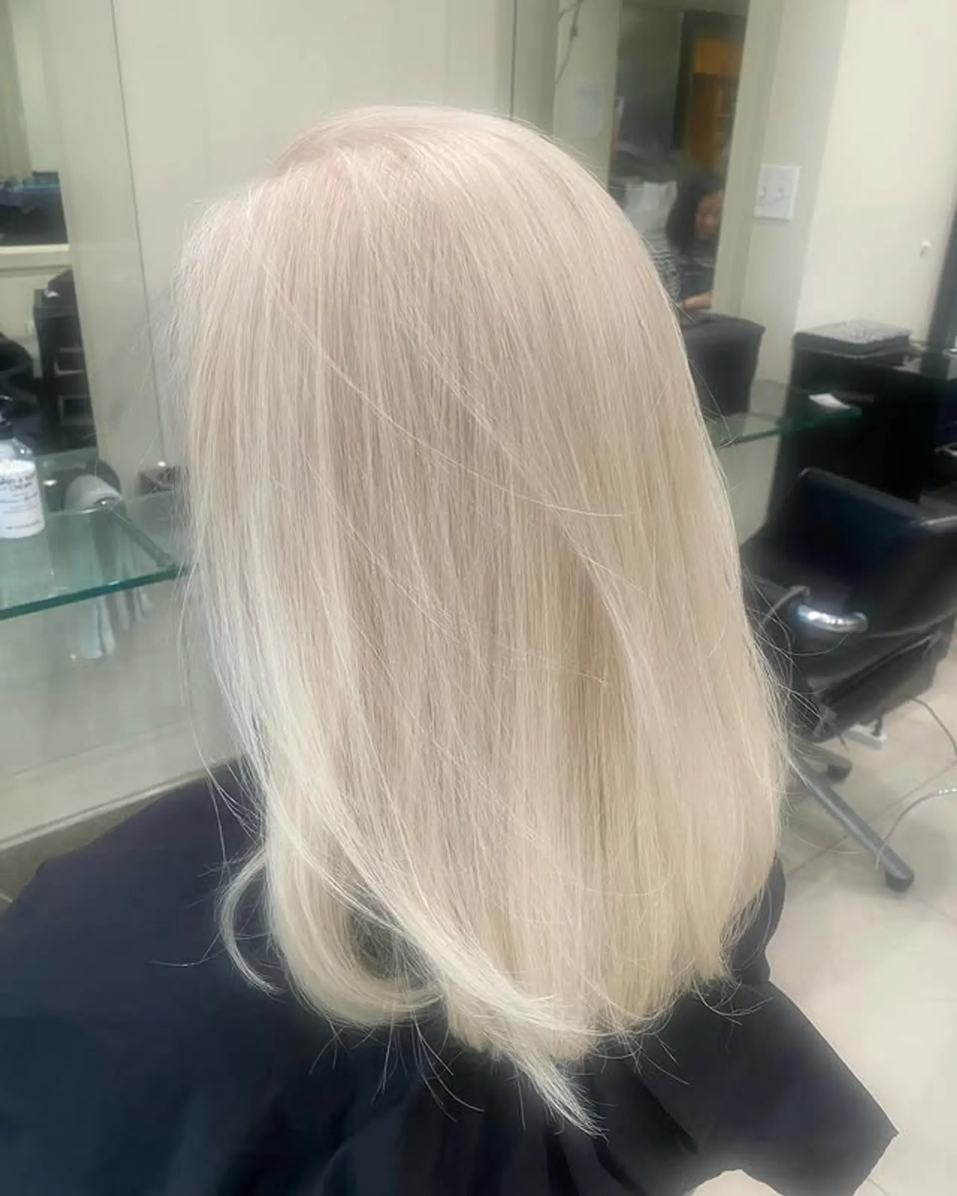 This is a medium length straight hairstyle with sleek texture and uniform length. 1